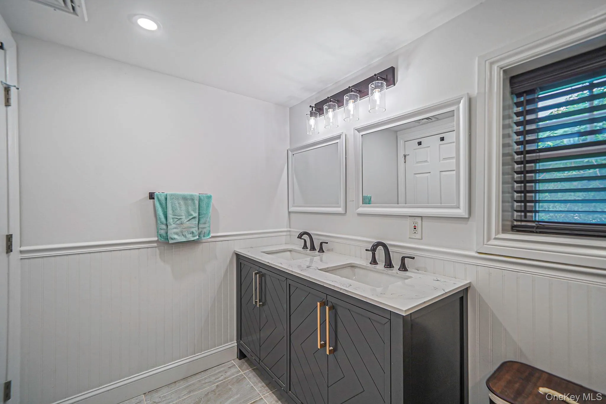 Bathroom with wainscoting and double vanity Bathroom with wainscoting and double vanity