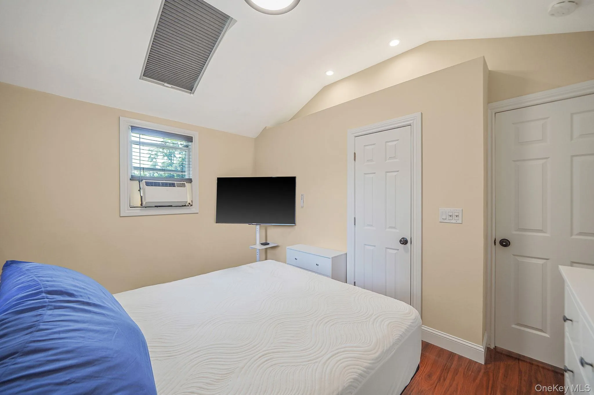 Bedroom featuring lofted ceiling, dark wood-type flooring, and recessed lighting Bedroom featuring lofted ceiling, dark wood-type flooring, and recessed lighting
