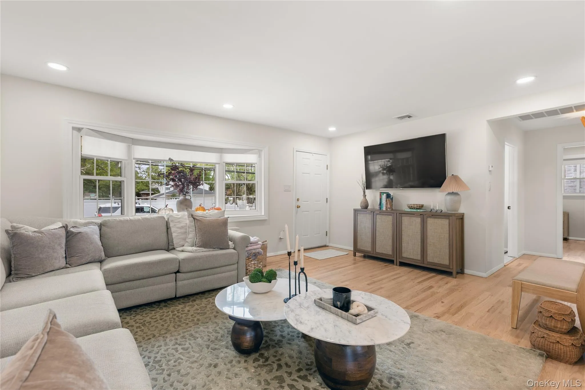 Living room featuring light wood finished floors and recessed lighting Living room featuring light wood finished floors and recessed lighting