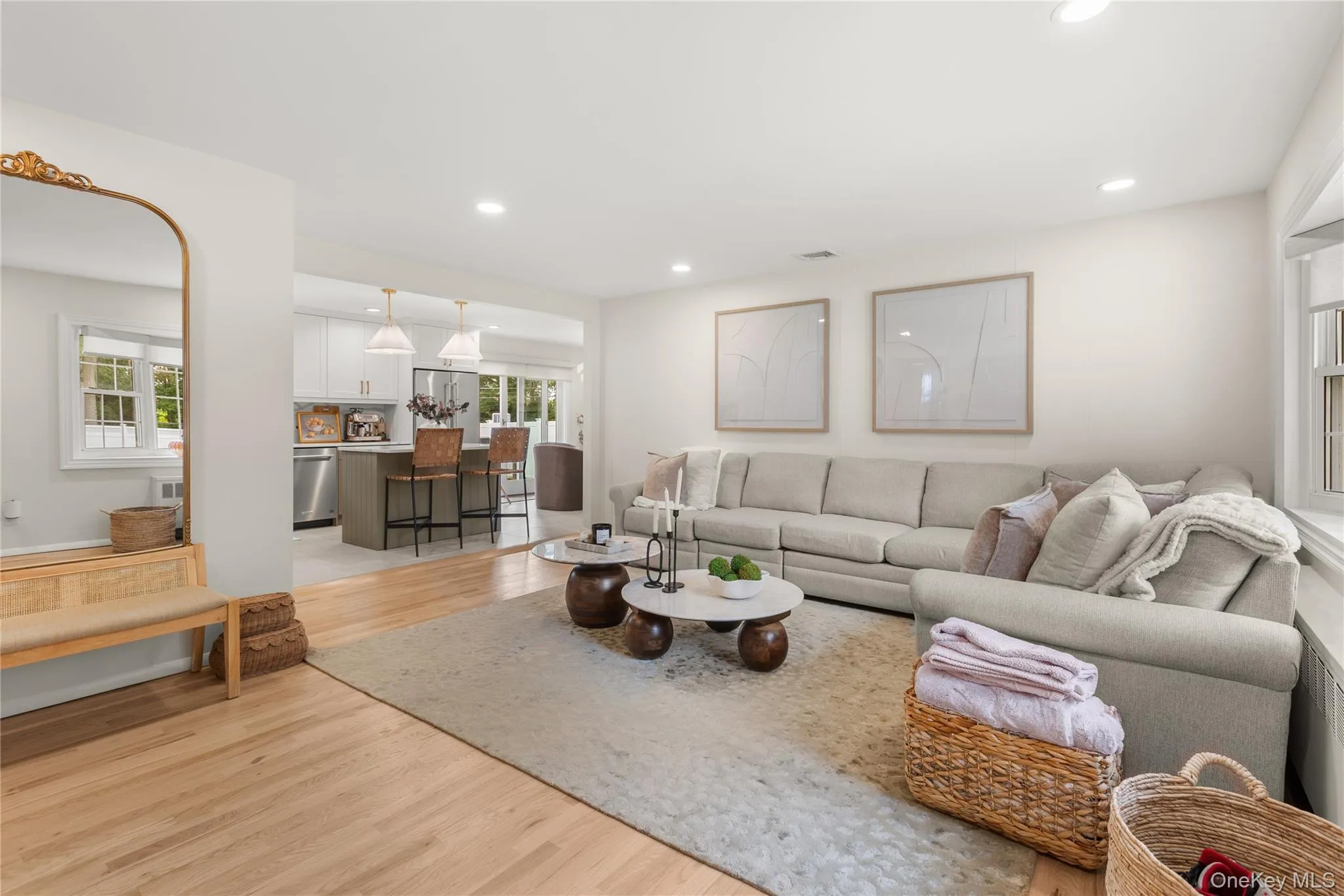 Living room with light wood finished floors and recessed lighting Living room with light wood finished floors and recessed lighting