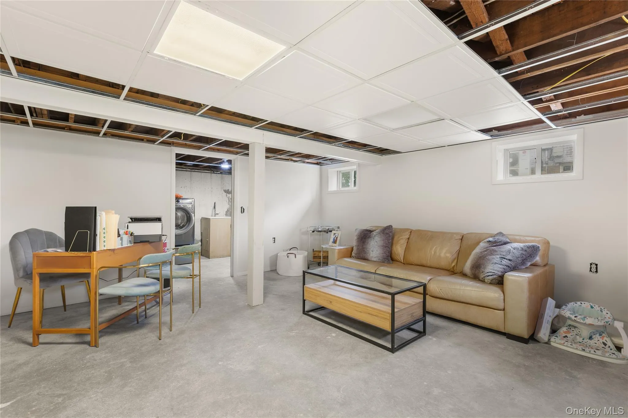 Living area featuring washer / dryer and concrete floors Living area featuring washer / dryer and concrete floors