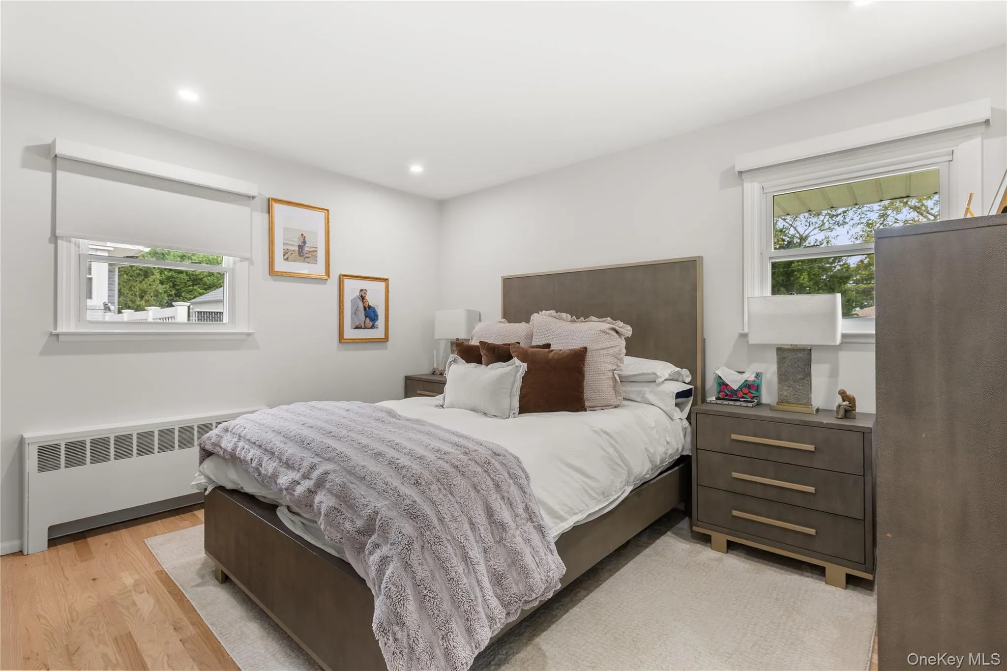 Bedroom featuring radiator, light wood-style flooring, and recessed lighting Bedroom featuring radiator, light wood-style flooring, and recessed lighting