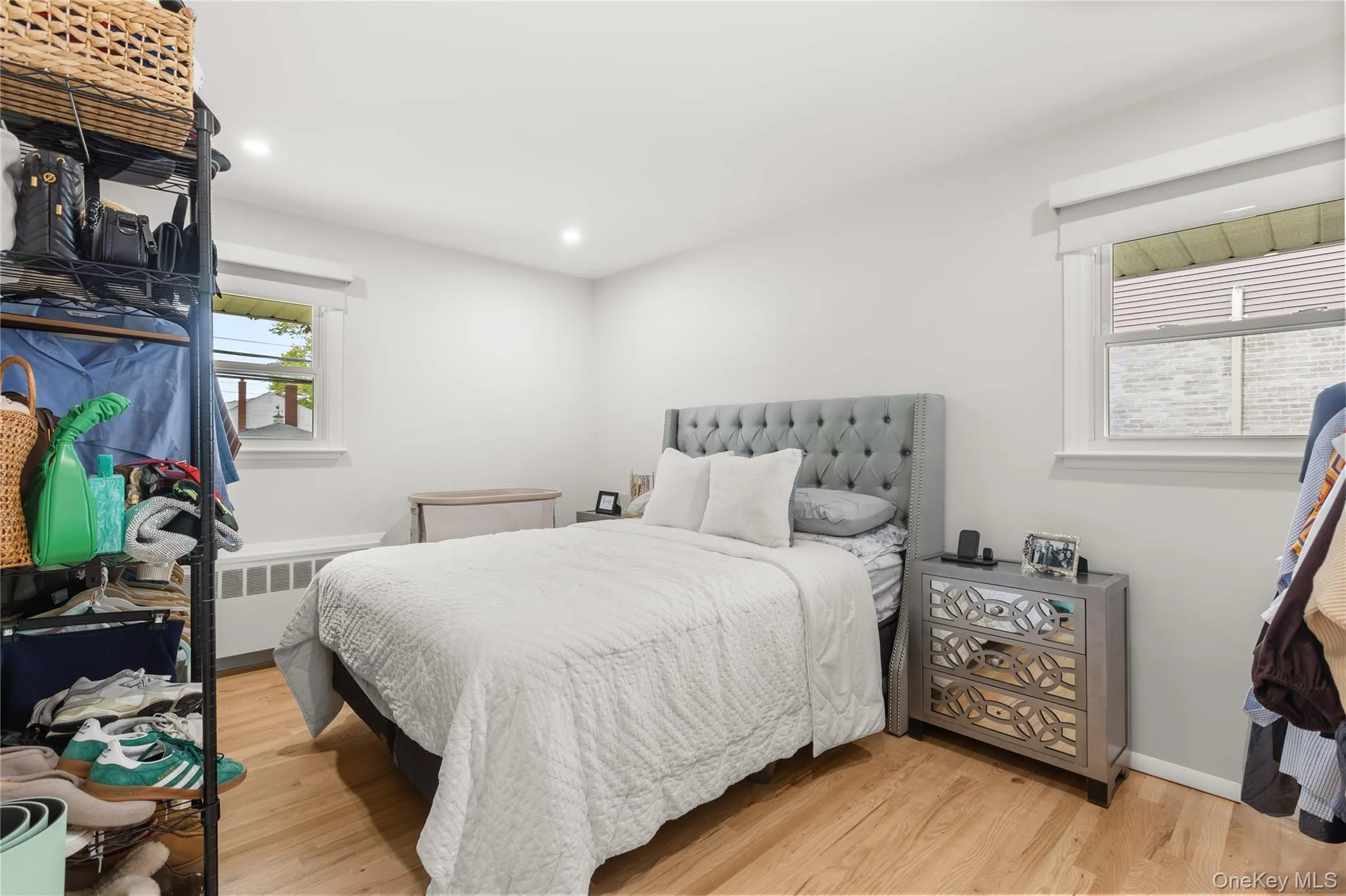 Bedroom with light wood-type flooring, recessed lighting, and radiator Bedroom with light wood-type flooring, recessed lighting, and radiator