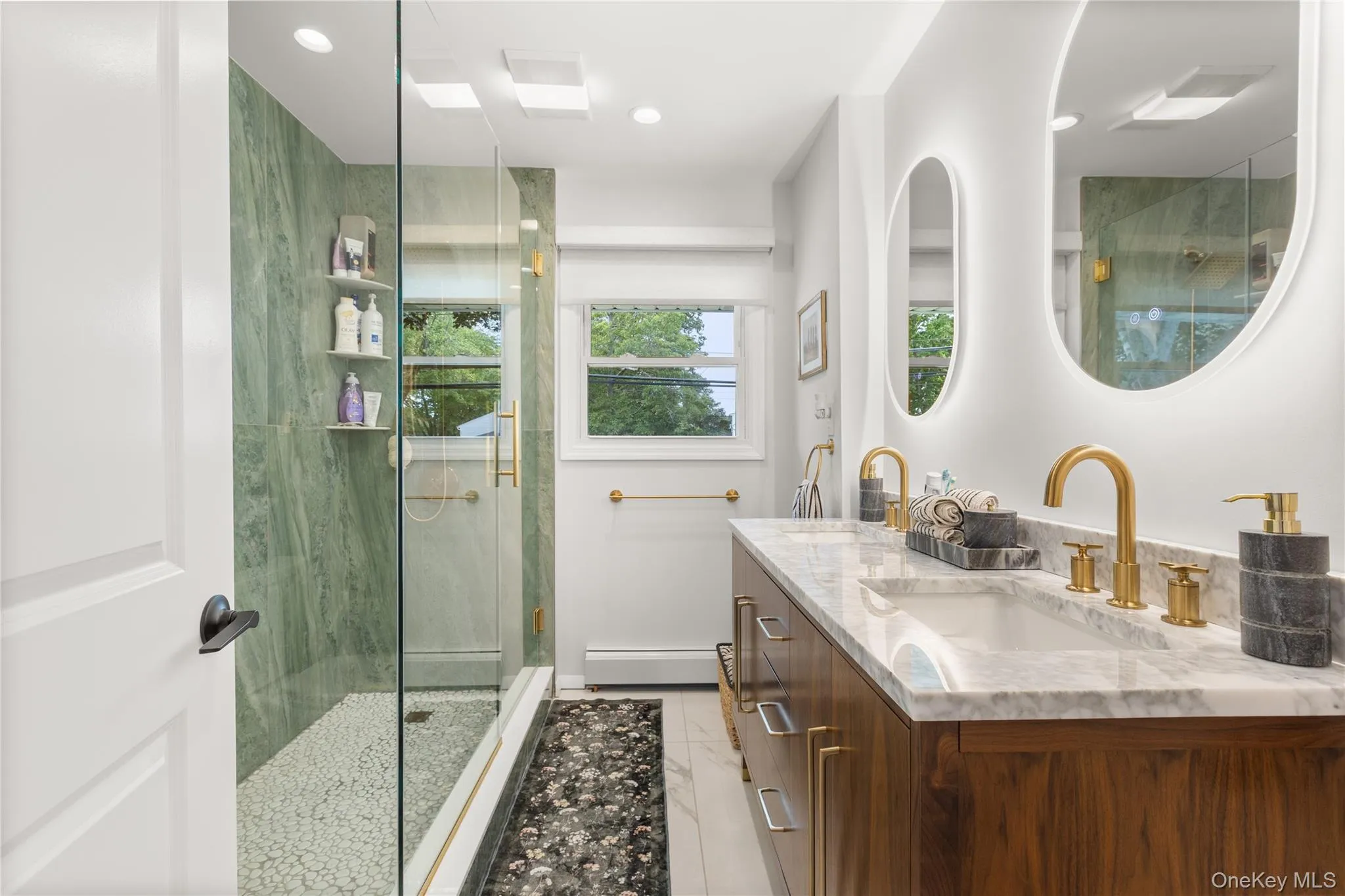 Bathroom featuring a stall shower, double vanity, a baseboard radiator, and recessed lighting Bathroom featuring a stall shower, double vanity, a baseboard radiator, and recessed lighting