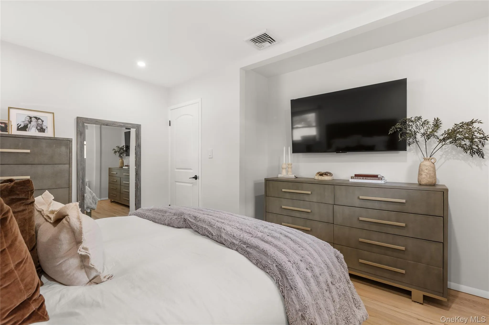Bedroom with light wood-type flooring and recessed lighting Bedroom with light wood-type flooring and recessed lighting