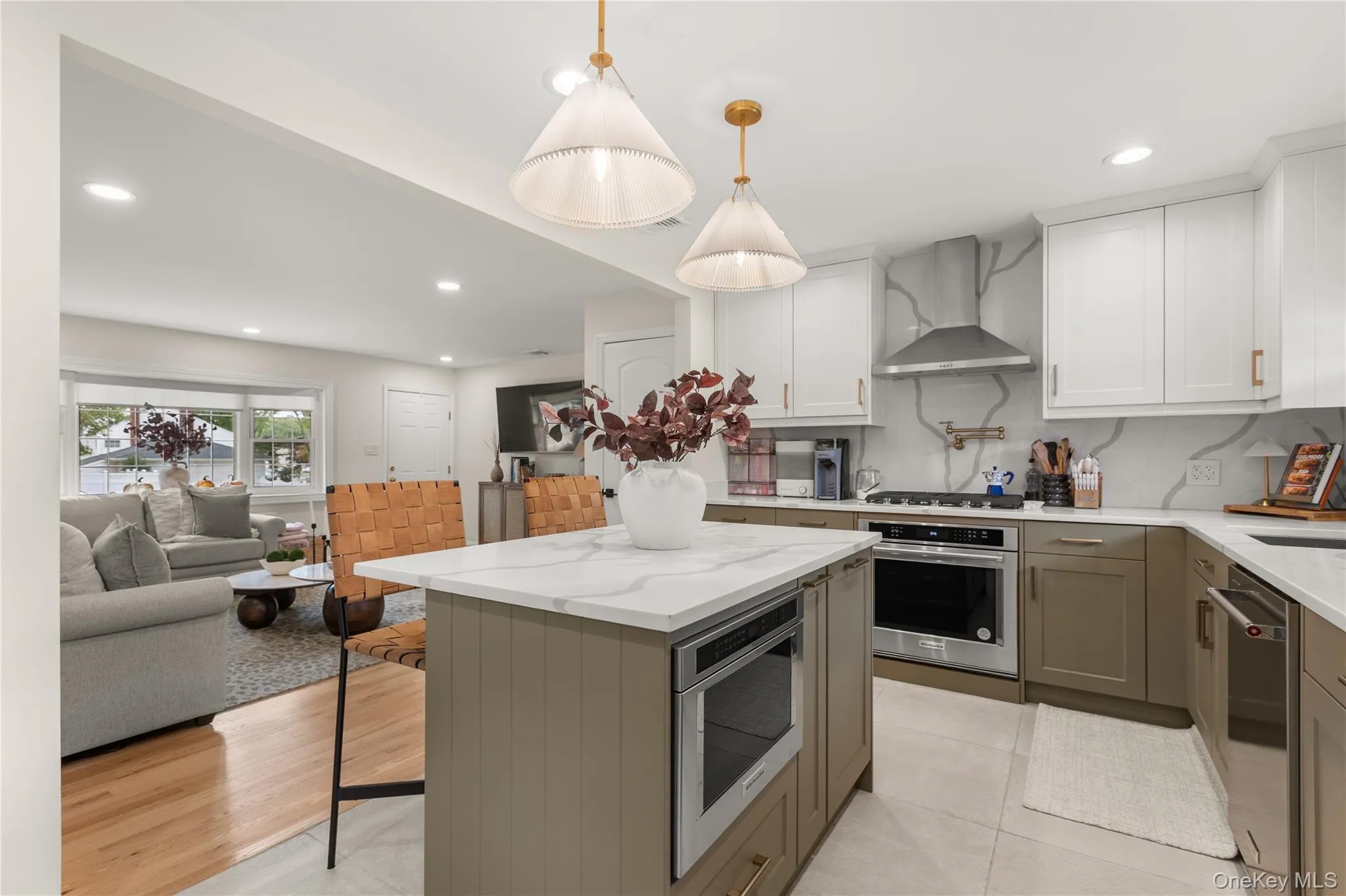 Kitchen featuring recessed lighting, open floor plan, backsplash, light stone countertops, and a kitchen island Kitchen featuring recessed lighting, open floor plan, backsplash, light stone countertops, and a kitchen island