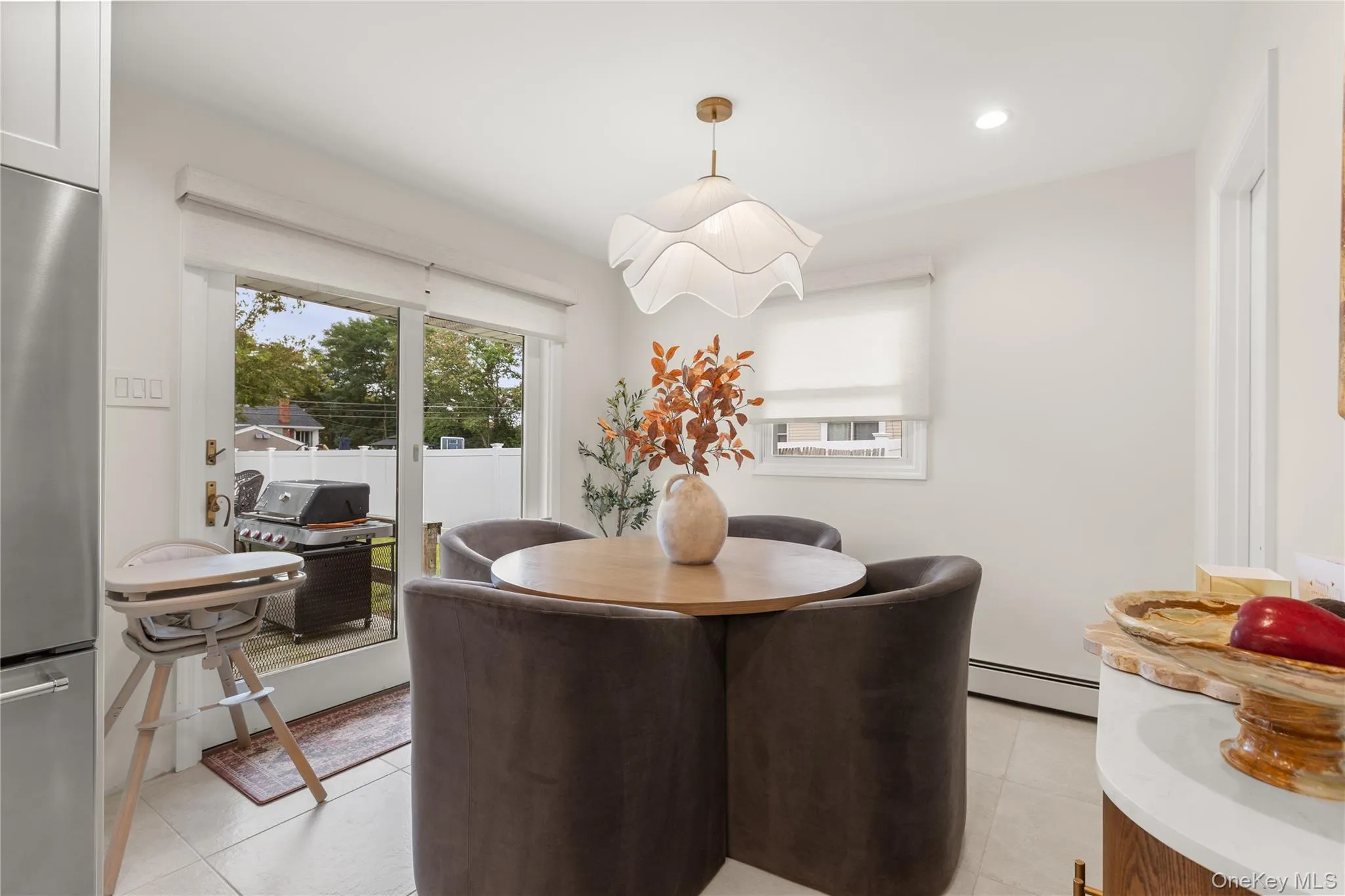 Dining room featuring light tile patterned floors, baseboard heating, and recessed lighting Dining room featuring light tile patterned floors, baseboard heating, and recessed lighting