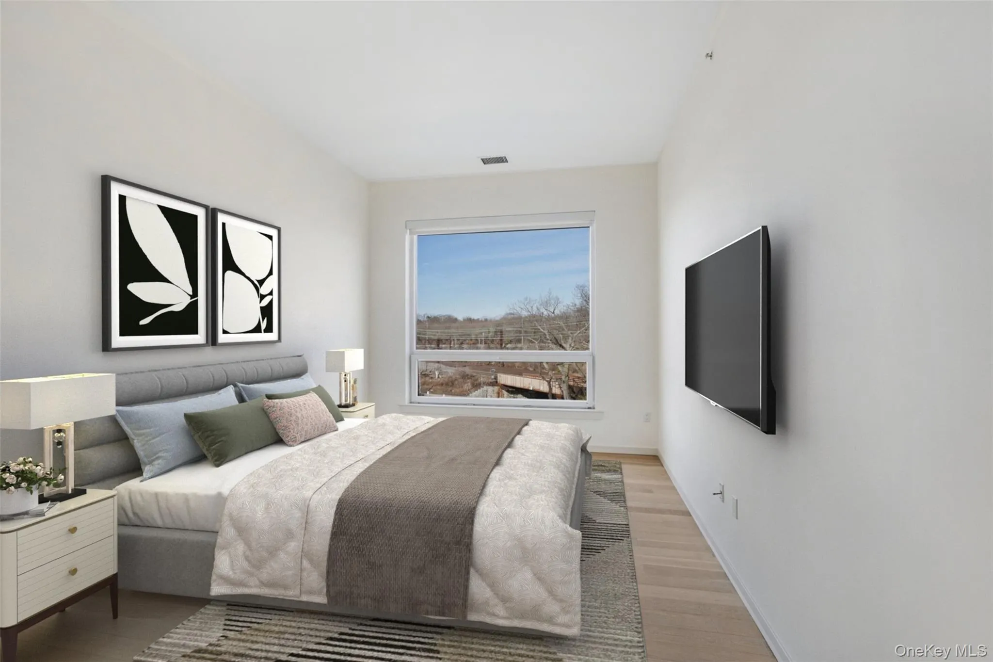 Bedroom with visible vents, light wood-style flooring, and baseboards Bedroom with visible vents, light wood-style flooring, and baseboards