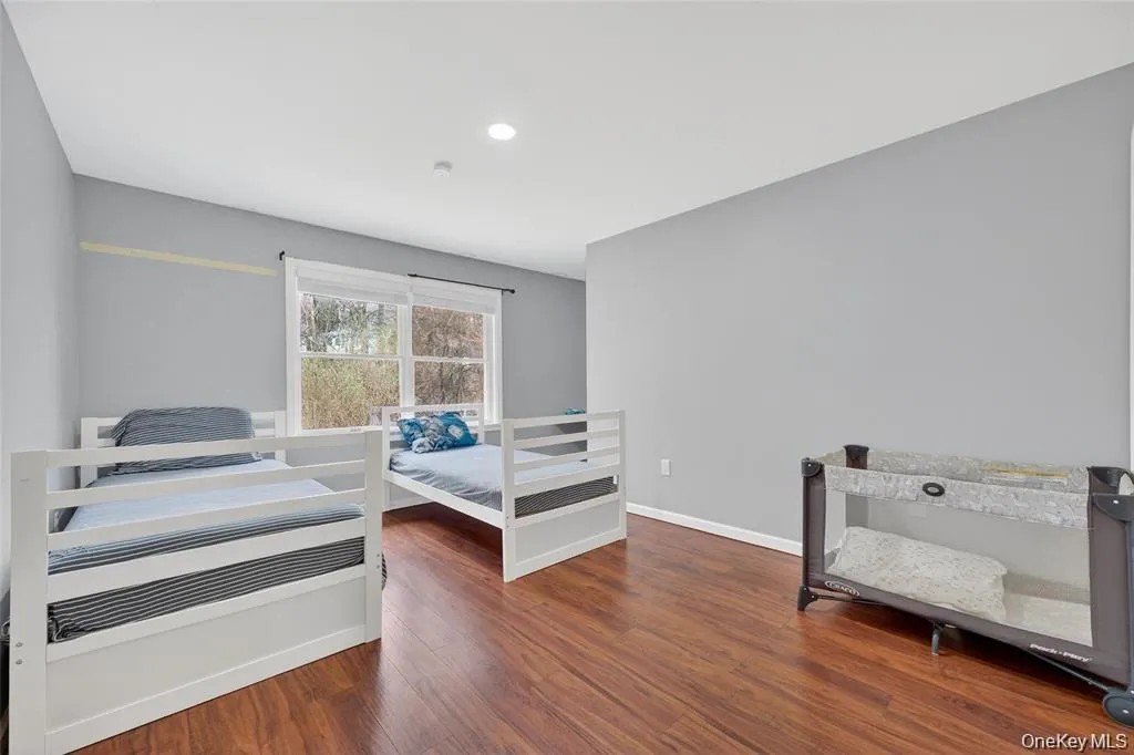 Bedroom featuring dark wood-style flooring and recessed lighting Bedroom featuring dark wood-style flooring and recessed lighting