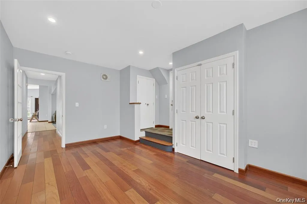 Unfurnished room with light wood-style flooring, a closet, and recessed lighting Unfurnished room with light wood-style flooring, a closet, and recessed lighting