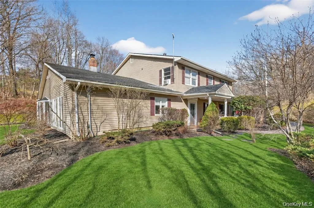 View of front of property with a front lawn, a chimney, and a porch View of front of property with a front lawn, a chimney, and a porch