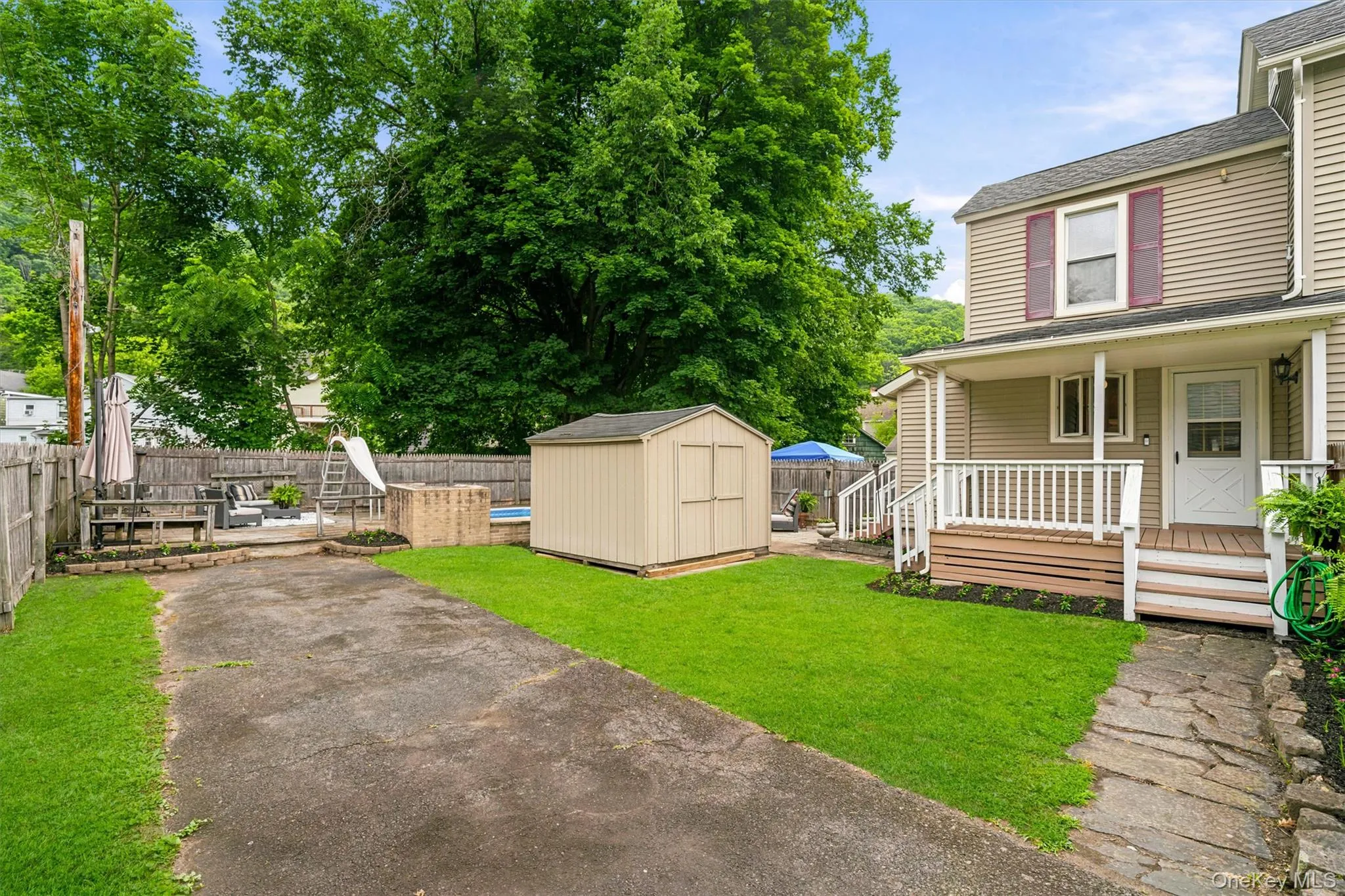 View of side yard, covered deck and shed View of side yard, covered deck and shed