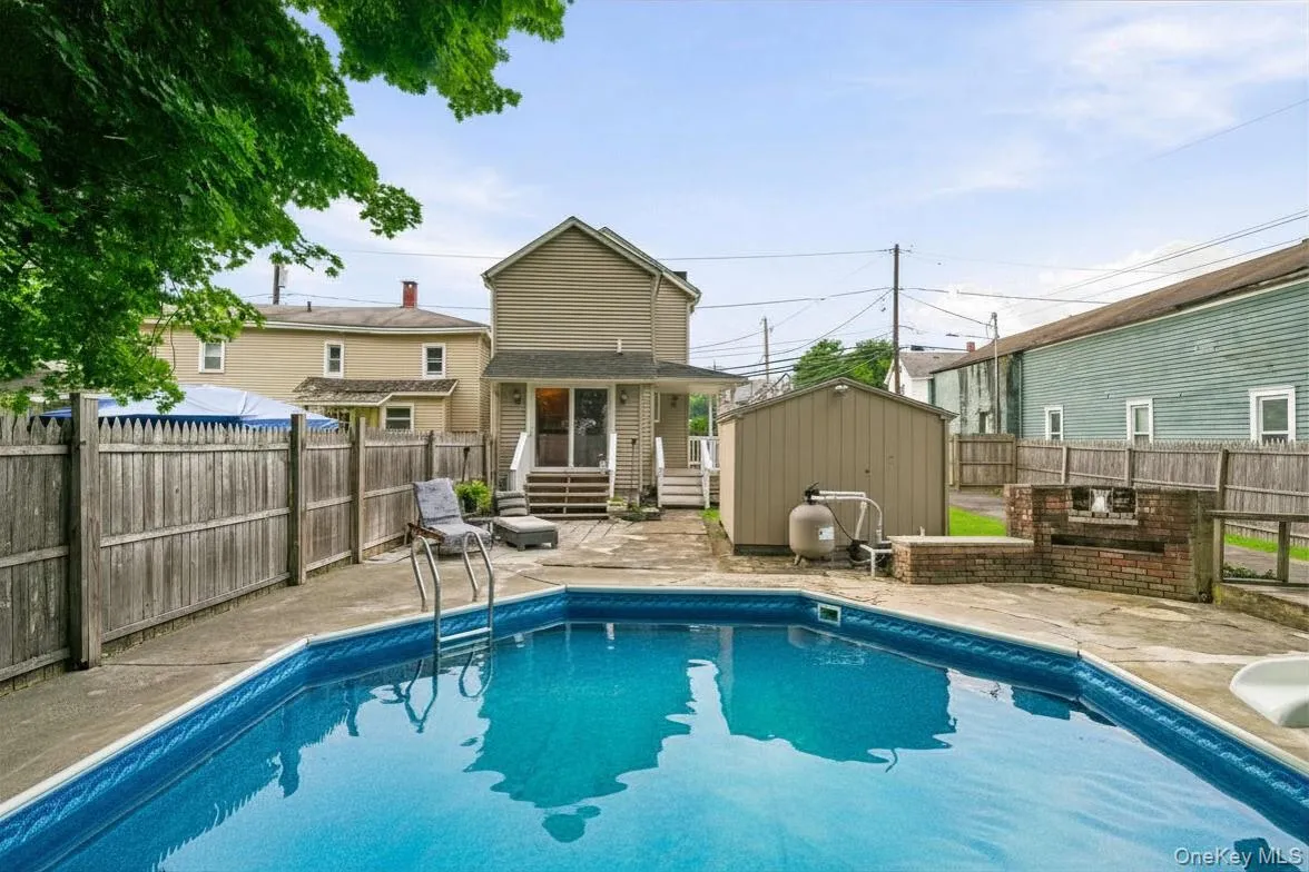 View of pool and back of home View of pool and back of home