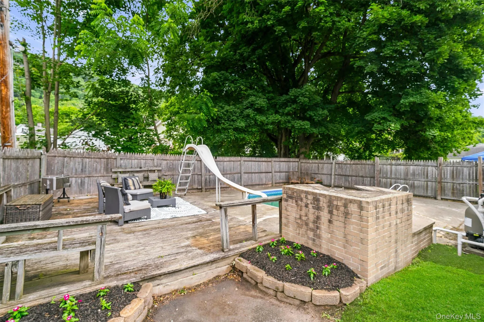 View of deck and pool from backyard View of deck and pool from backyard