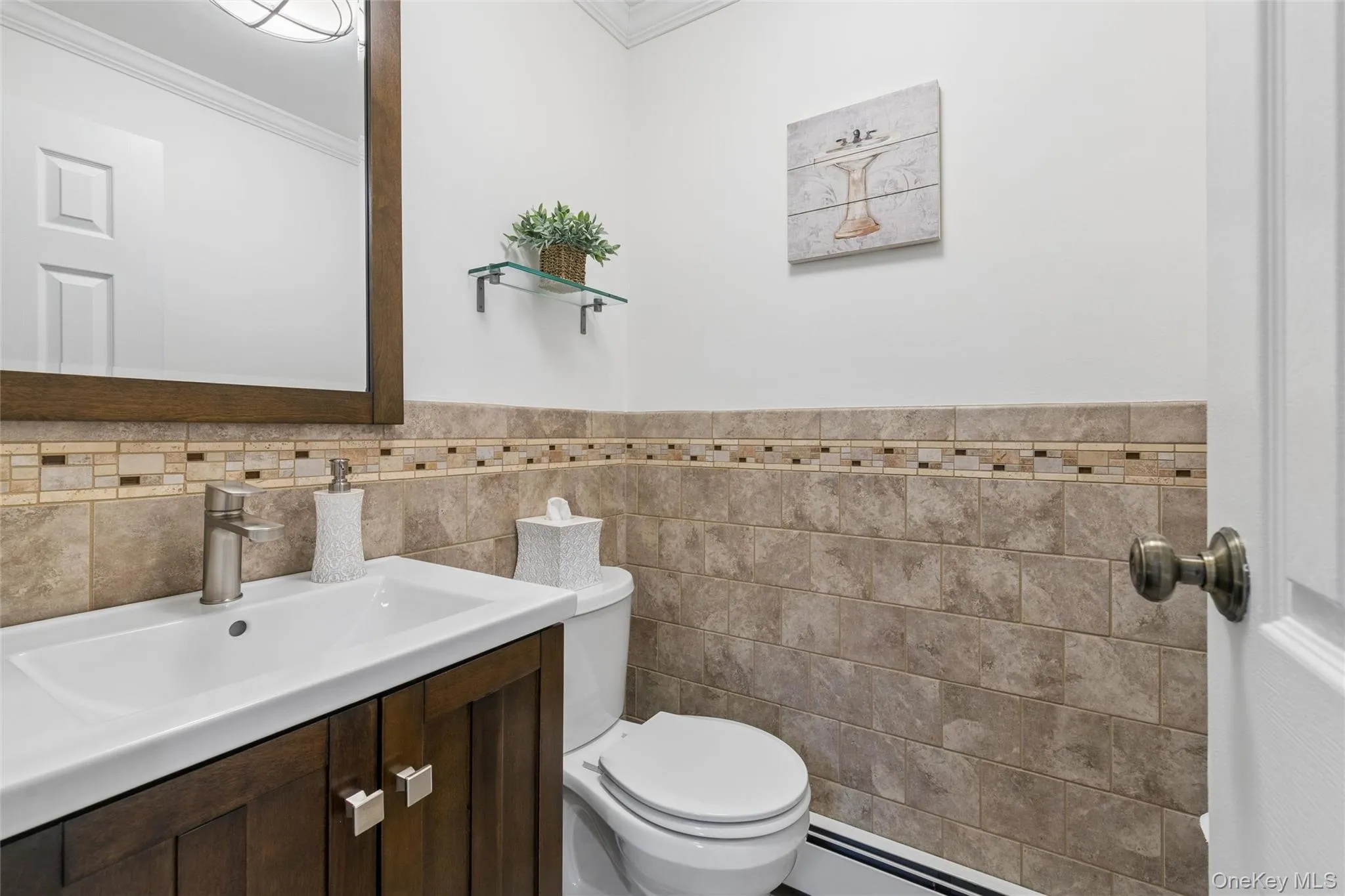 Vanity with integrated sink, wood-framed mirror, and satin nickel faucet Vanity with integrated sink, wood-framed mirror, and satin nickel faucet