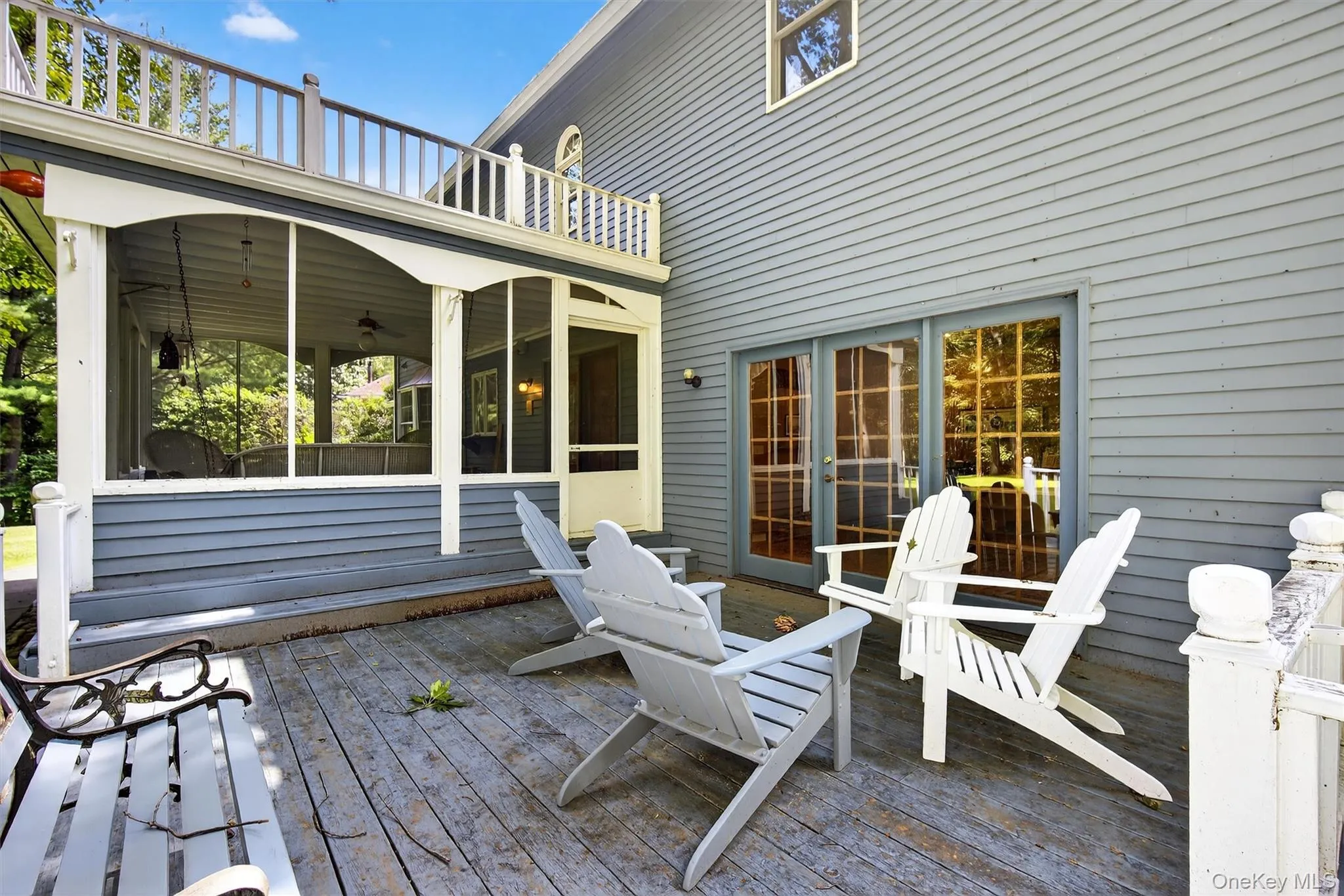 Wooden deck featuring a sunroom Wooden deck featuring a sunroom