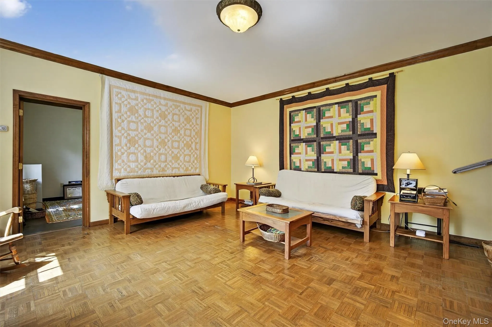 Living room featuring ornamental molding and a baseboard heating unit Living room featuring ornamental molding and a baseboard heating unit