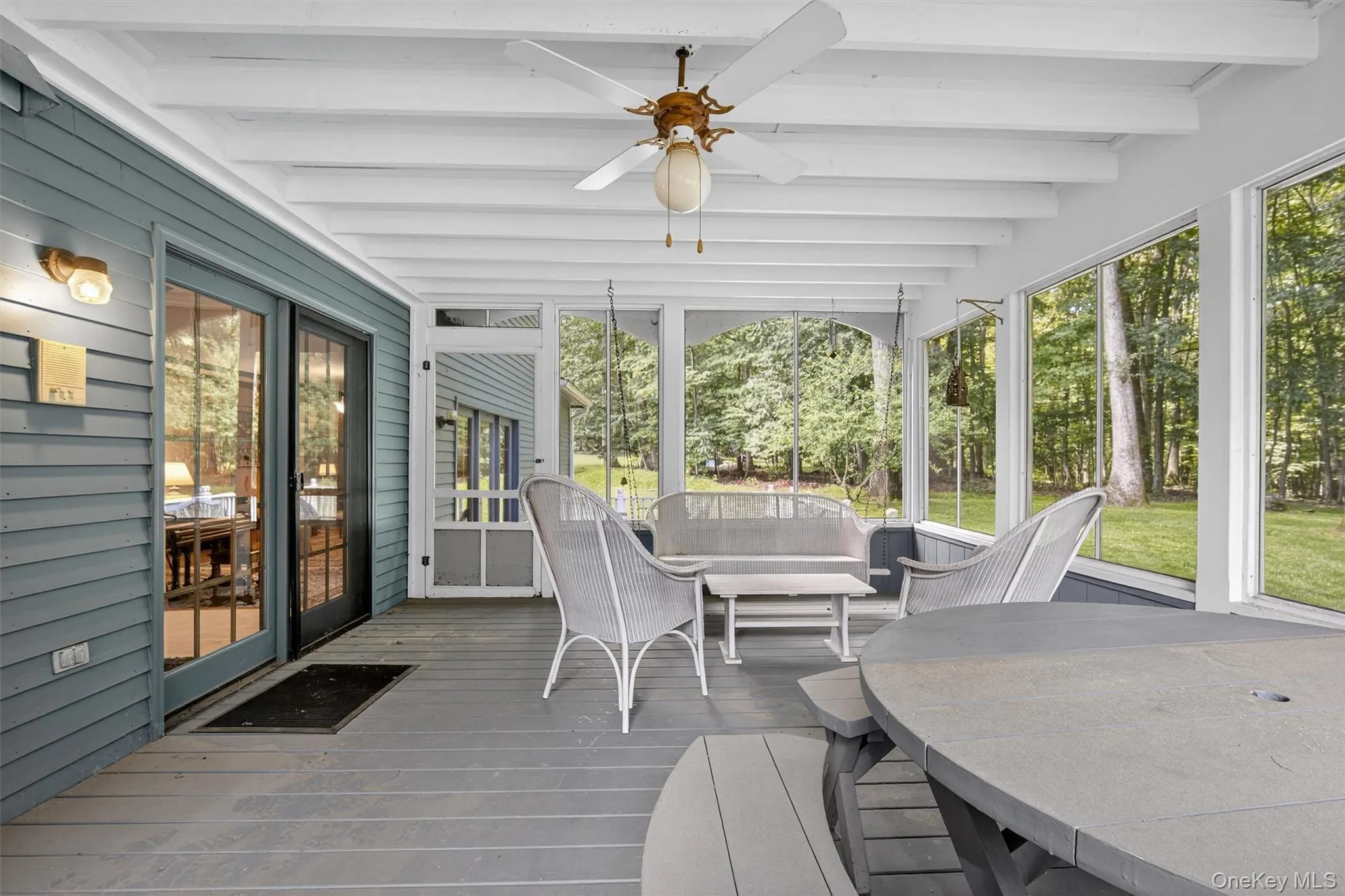 Sunroom / solarium with beam ceiling and ceiling fan Sunroom / solarium with beam ceiling and ceiling fan