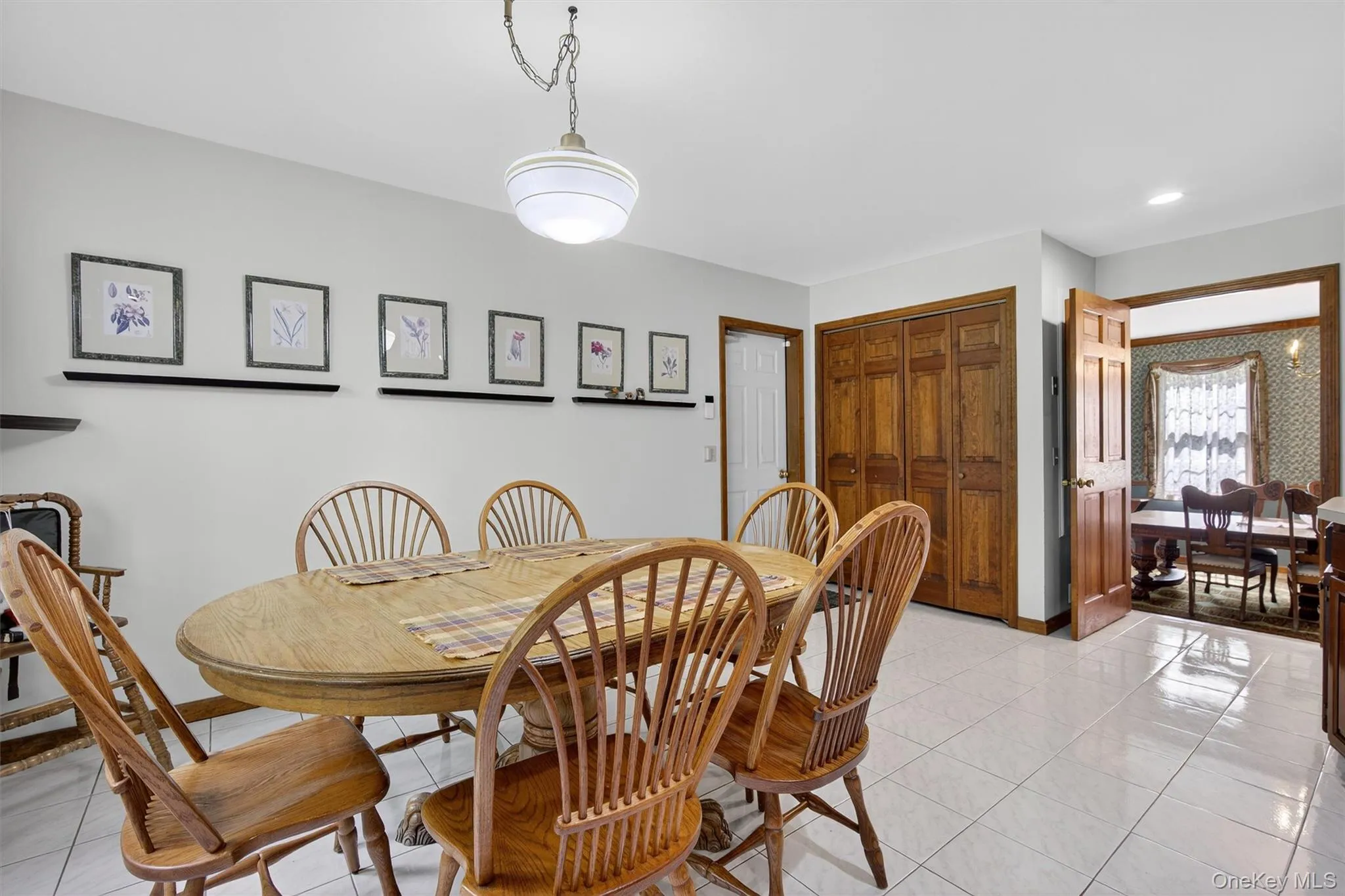 Dining room featuring light tile patterned flooring and baseboards Dining room featuring light tile patterned flooring and baseboards