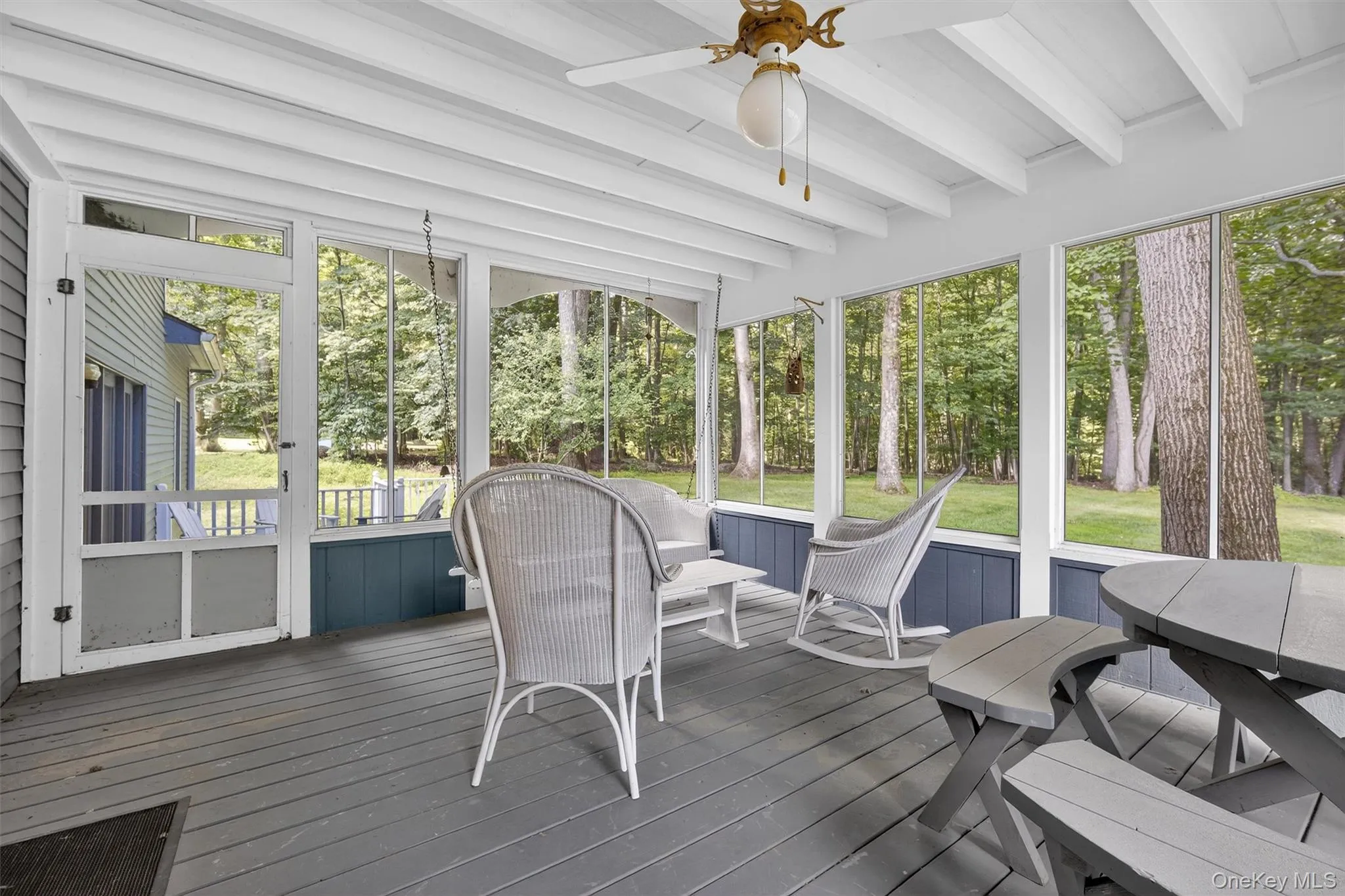 Sunroom with a ceiling fan, beam ceiling, and healthy amount of natural light Sunroom with a ceiling fan, beam ceiling, and healthy amount of natural light