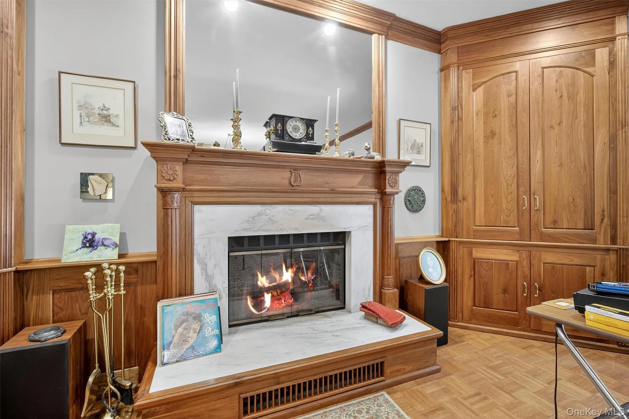 Sitting room featuring a high end fireplace and wainscoting Sitting room featuring a high end fireplace and wainscoting