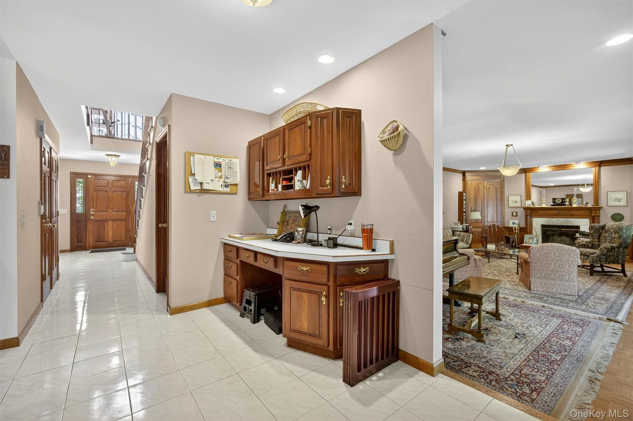 Bar with a glass covered fireplace, light tile patterned floors, and recessed lighting Bar with a glass covered fireplace, light tile patterned floors, and recessed lighting