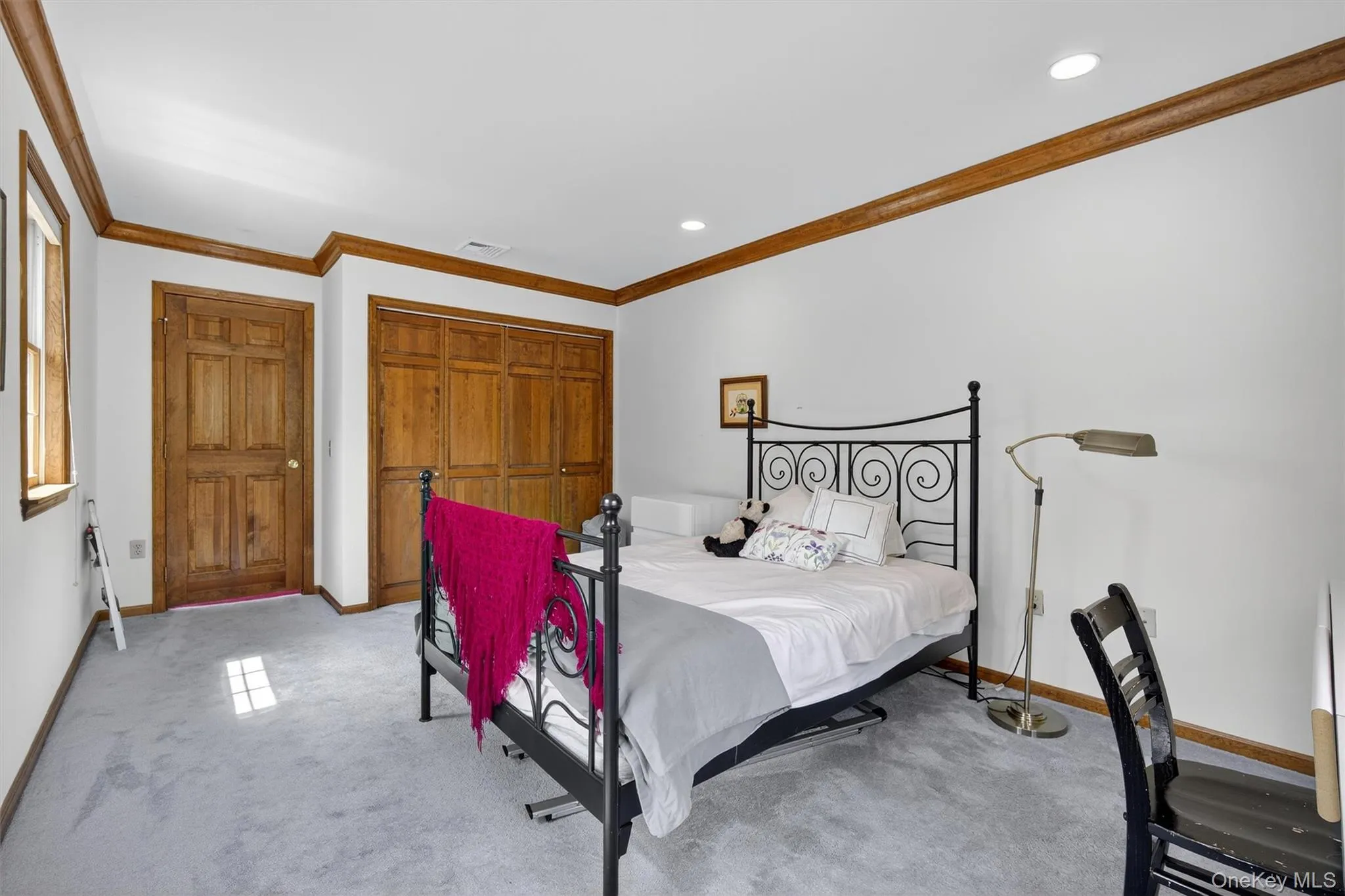 Bedroom with light carpet, ornamental molding, and recessed lighting Bedroom with light carpet, ornamental molding, and recessed lighting
