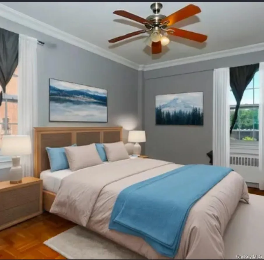 Bedroom featuring crown molding, radiator, and ceiling fan Bedroom featuring crown molding, radiator, and ceiling fan