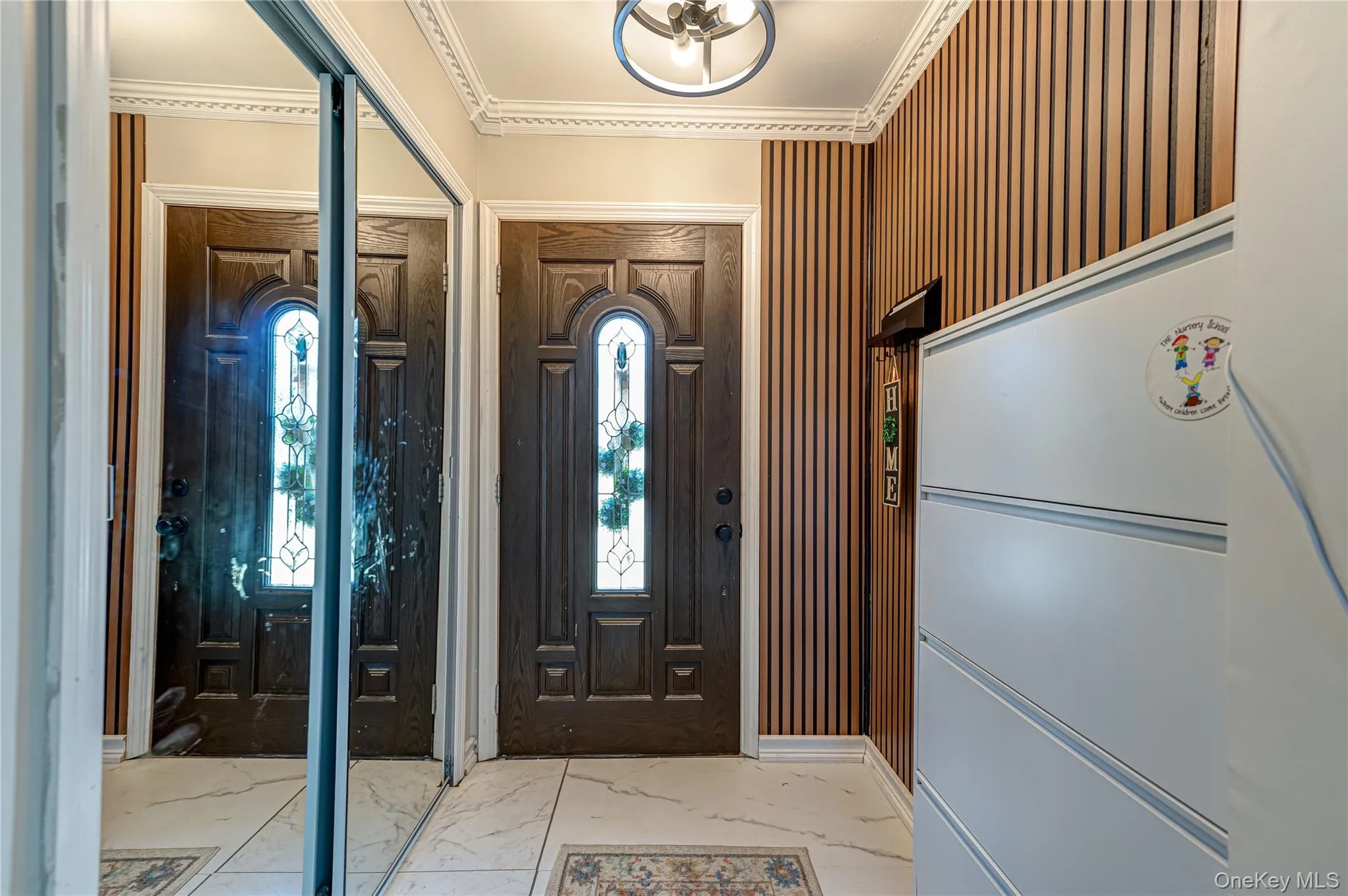 Entry Foyer with Double Closet and Wood Paneling Entry Foyer with Double Closet and Wood Paneling