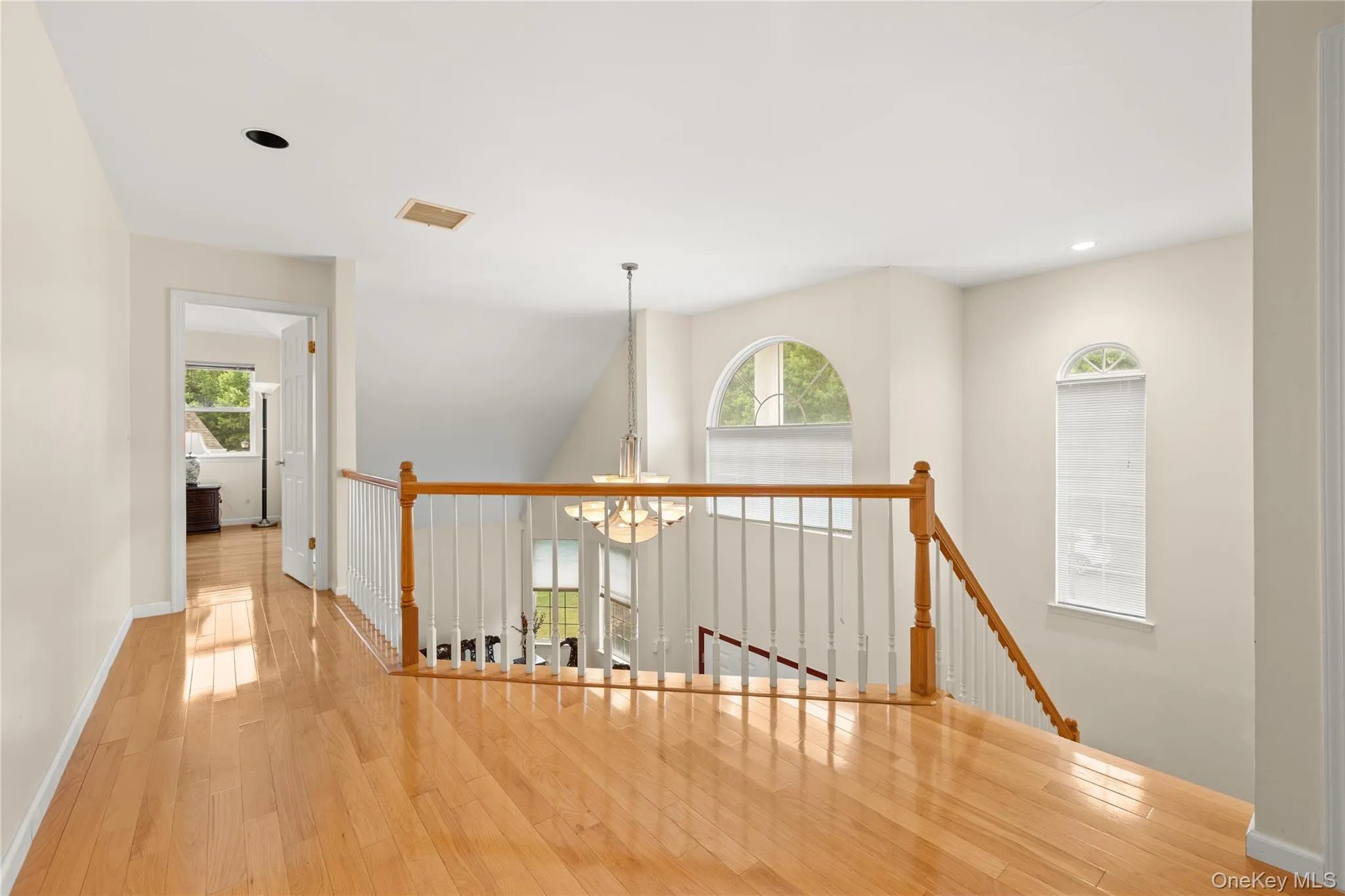 Upper-level landing featuring hardwood flooring Upper-level landing featuring hardwood flooring