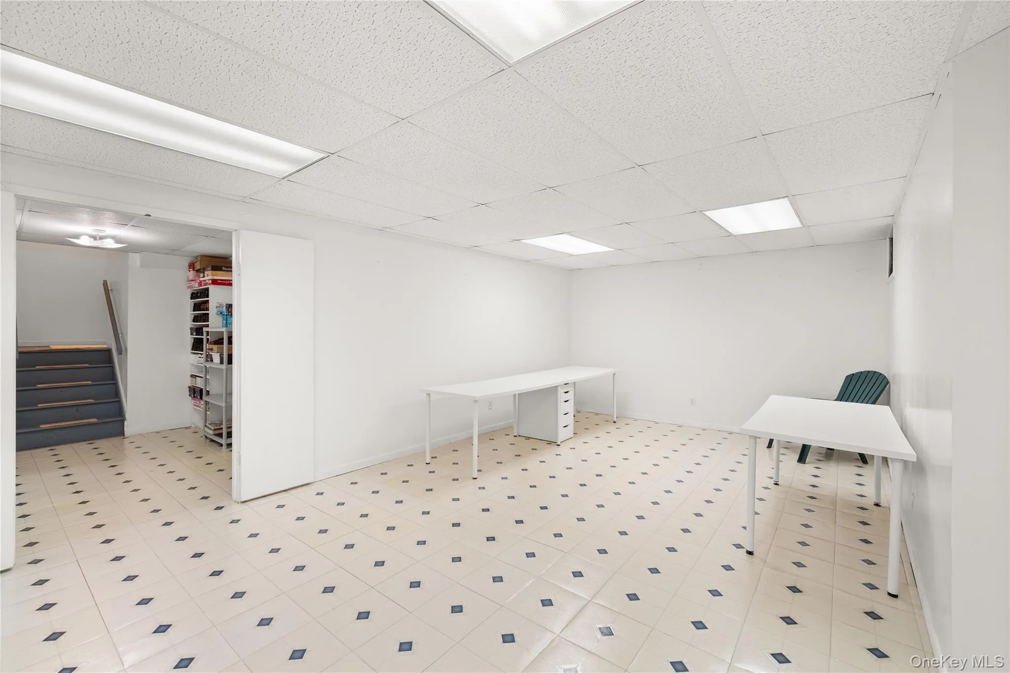 Finished basement with 3 rooms featuring white painted walls and a tile floor with a diamond pattern Finished basement with 3 rooms featuring white painted walls and a tile floor with a diamond pattern