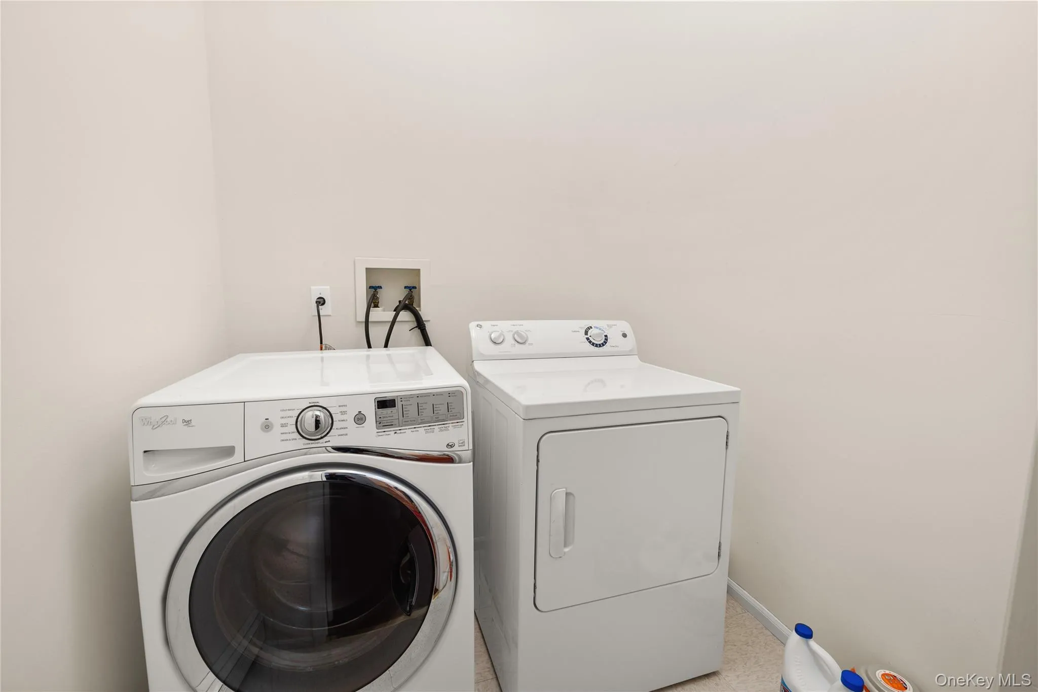 Dedicated main level laundry area featuring light-toned walls and a durable flooring surface Dedicated main level laundry area featuring light-toned walls and a durable flooring surface