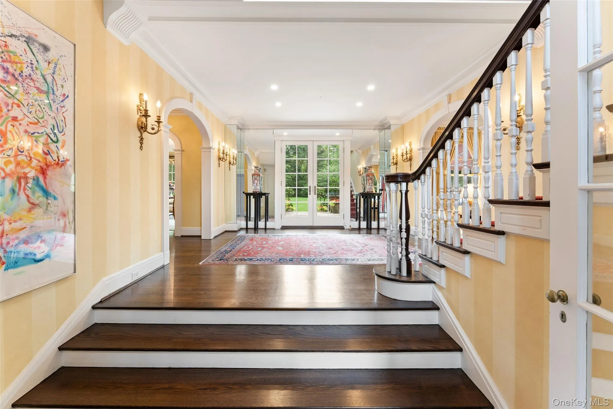 Grand entry foyer with french doors leading to backyard Grand entry foyer with french doors leading to backyard