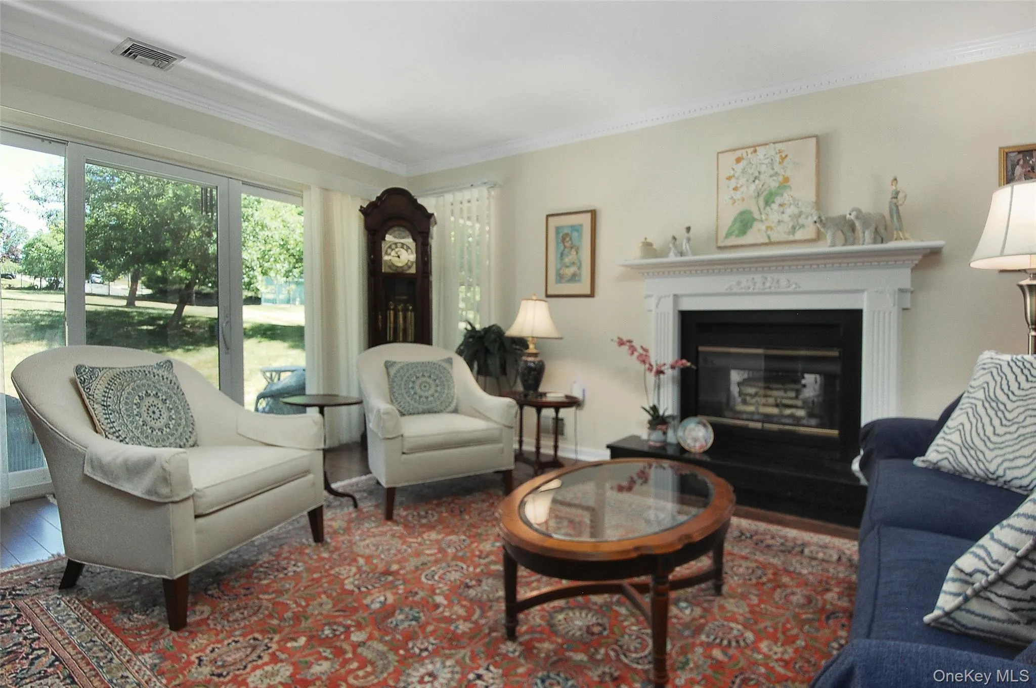 w/ crown moldings, fireplace & sliders to patio w/ crown moldings, fireplace & sliders to patio
