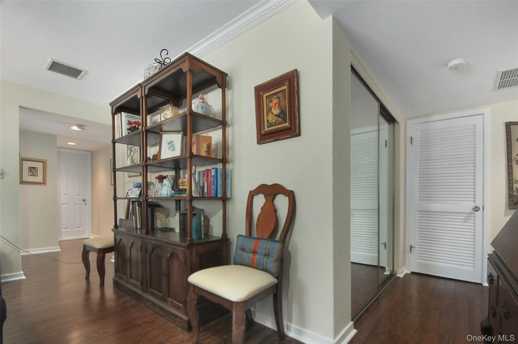 with closet + door to utility / laundry room with closet + door to utility / laundry room