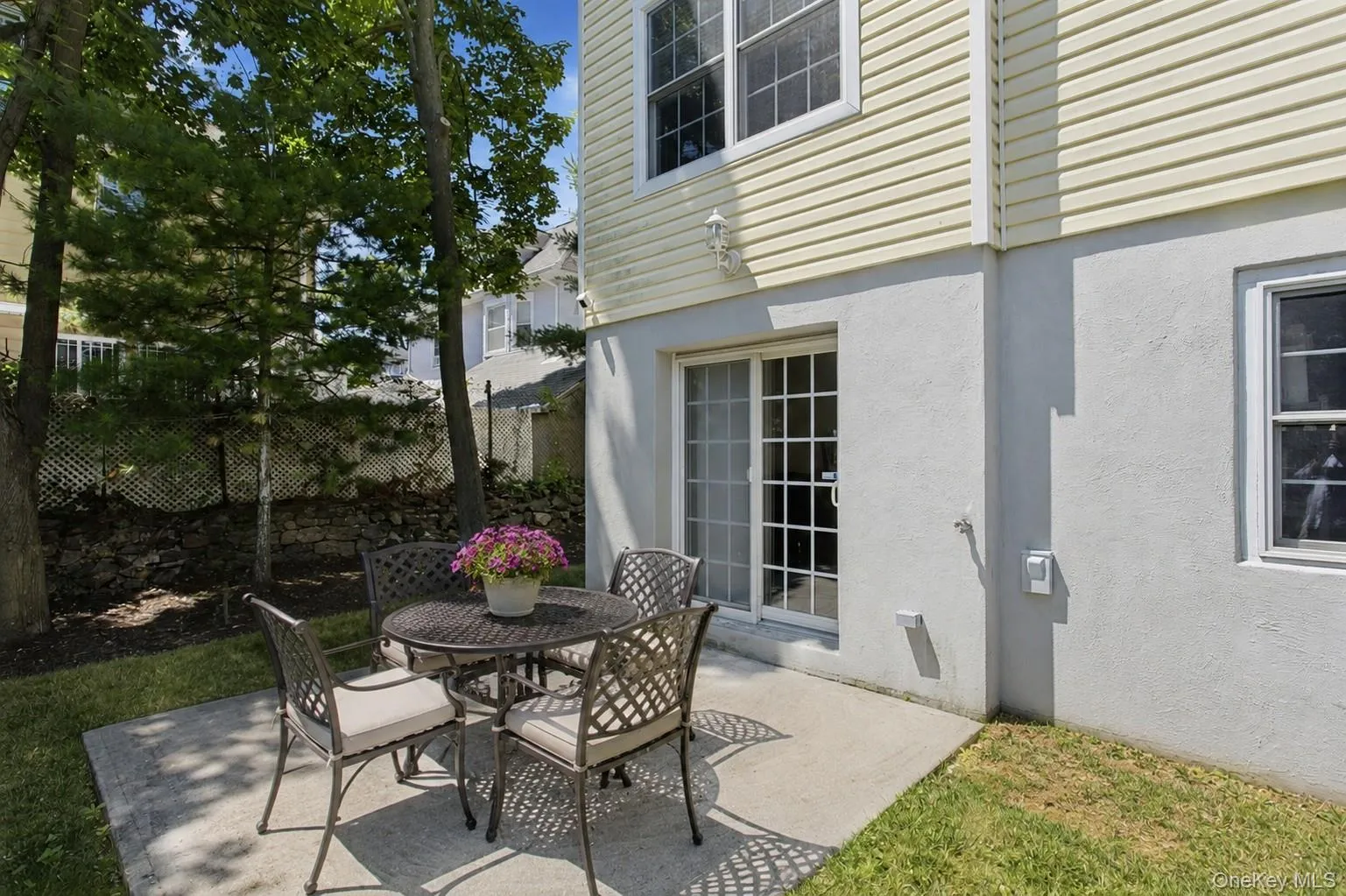 Patio with access to lower level. Virtually staged furniture. Patio with access to lower level. Virtually staged furniture.