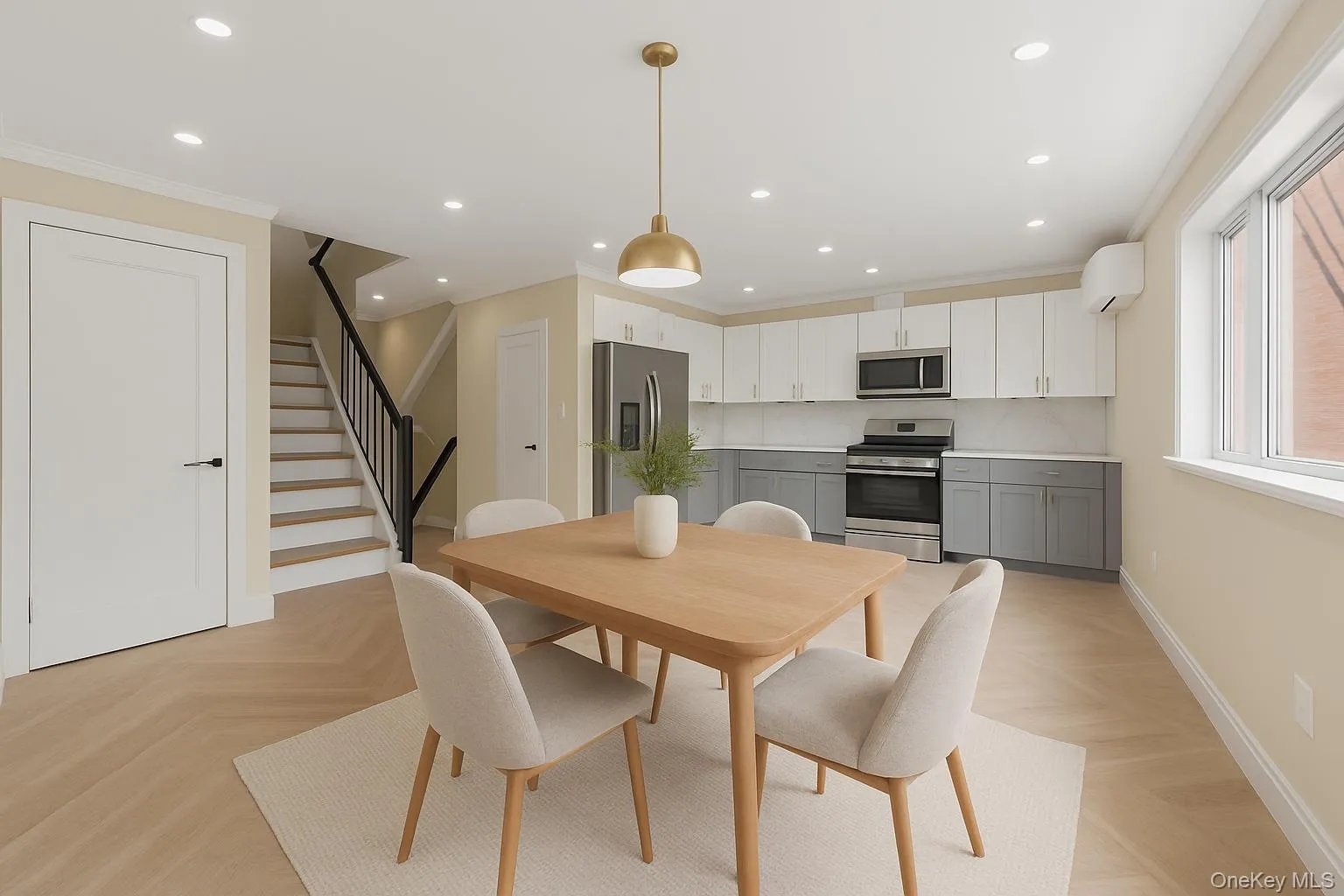 Open-concept living space with light wood-finish flooring in a herringbone pattern Open-concept living space with light wood-finish flooring in a herringbone pattern