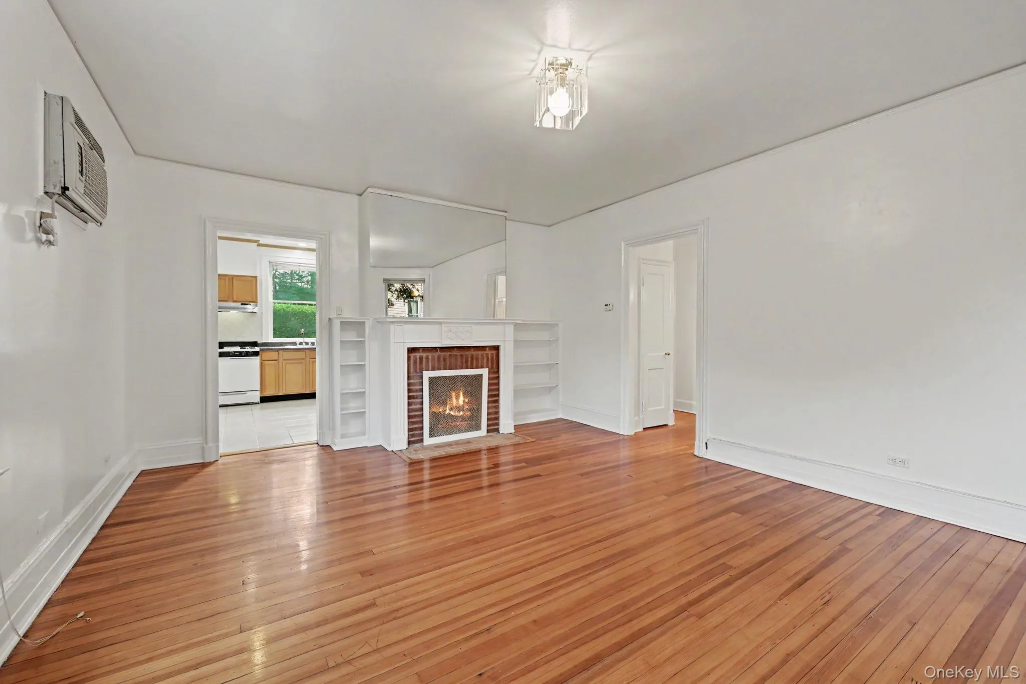 Warm wood-finish flooring complements the white walls of this room Warm wood-finish flooring complements the white walls of this room