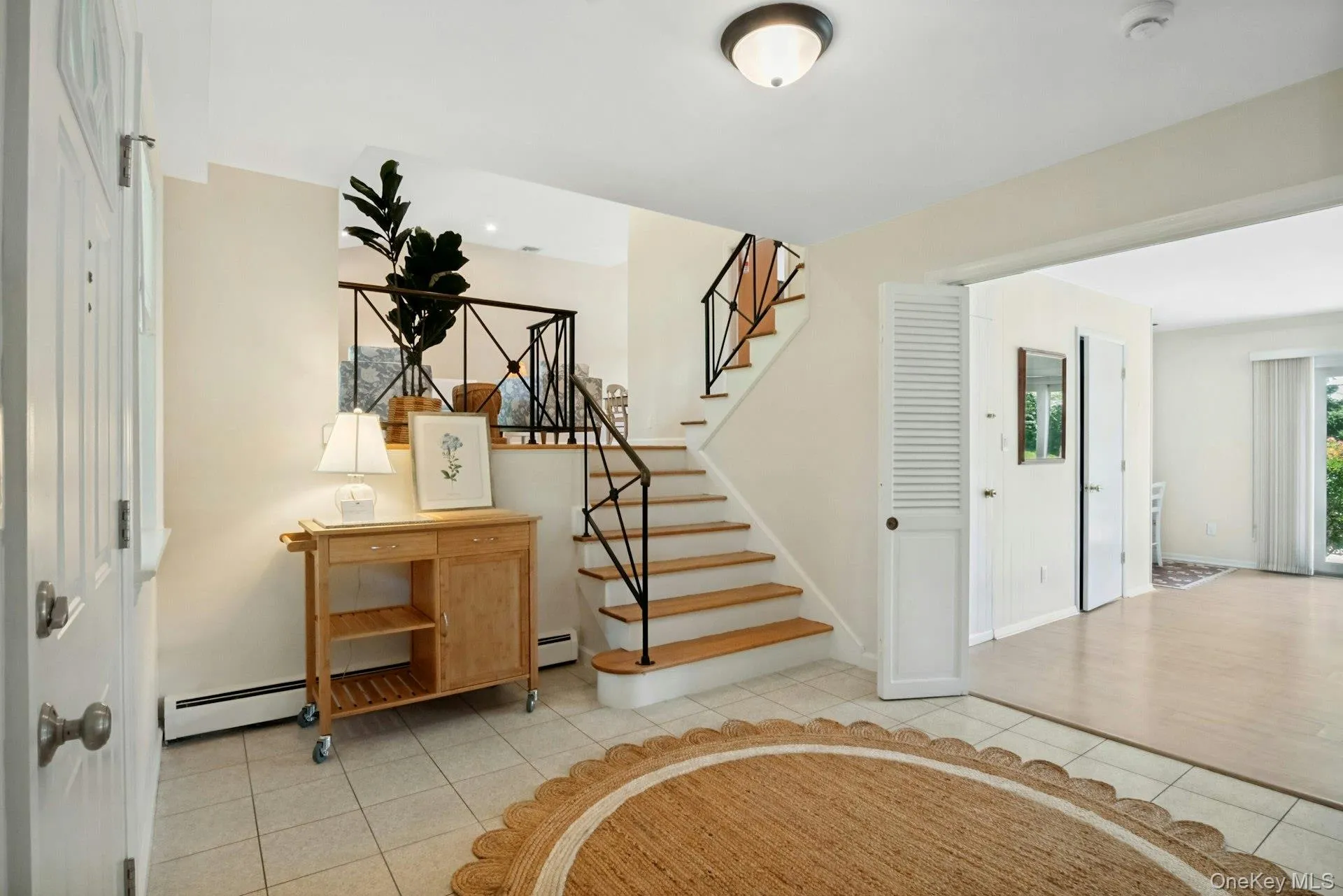 Alternate view of entry hall with large family room visible to the right Alternate view of entry hall with large family room visible to the right
