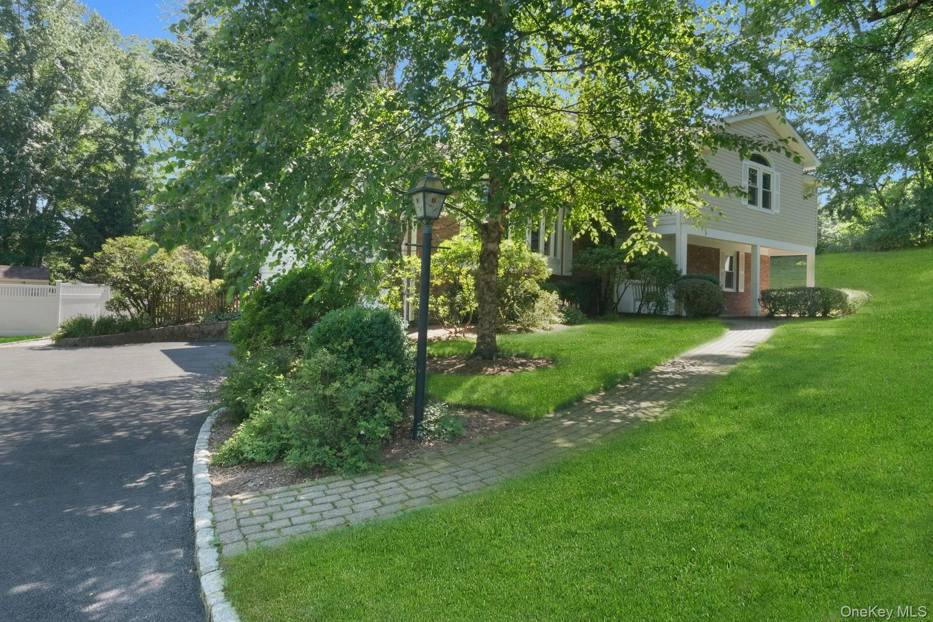 Young driveway leads to 2 car garage and the brick path to the front of the house. Young driveway leads to 2 car garage and the brick path to the front of the house.