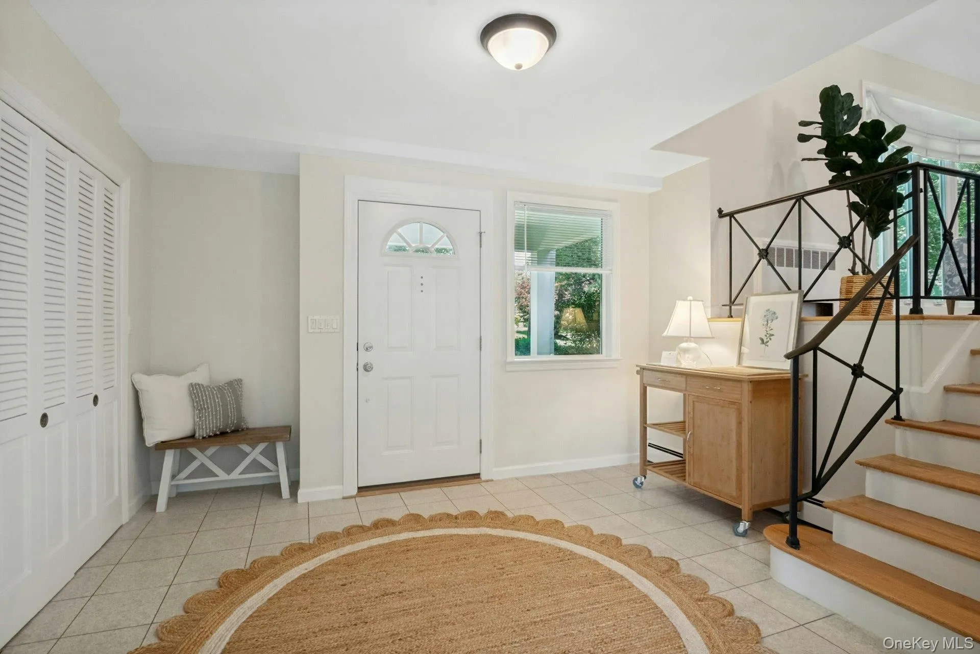 Bright inviting entry with steps leading up to first level and door to laundry to the left. Bright inviting entry with steps leading up to first level and door to laundry to the left.