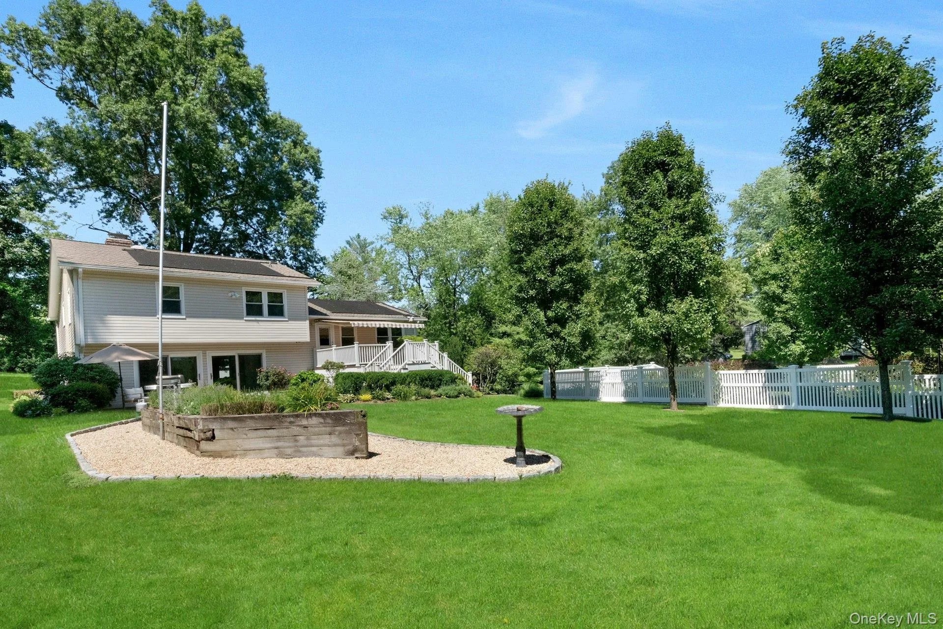 Looking from the backyard towards the fenced play yard and house and gardens. Looking from the backyard towards the fenced play yard and house and gardens.