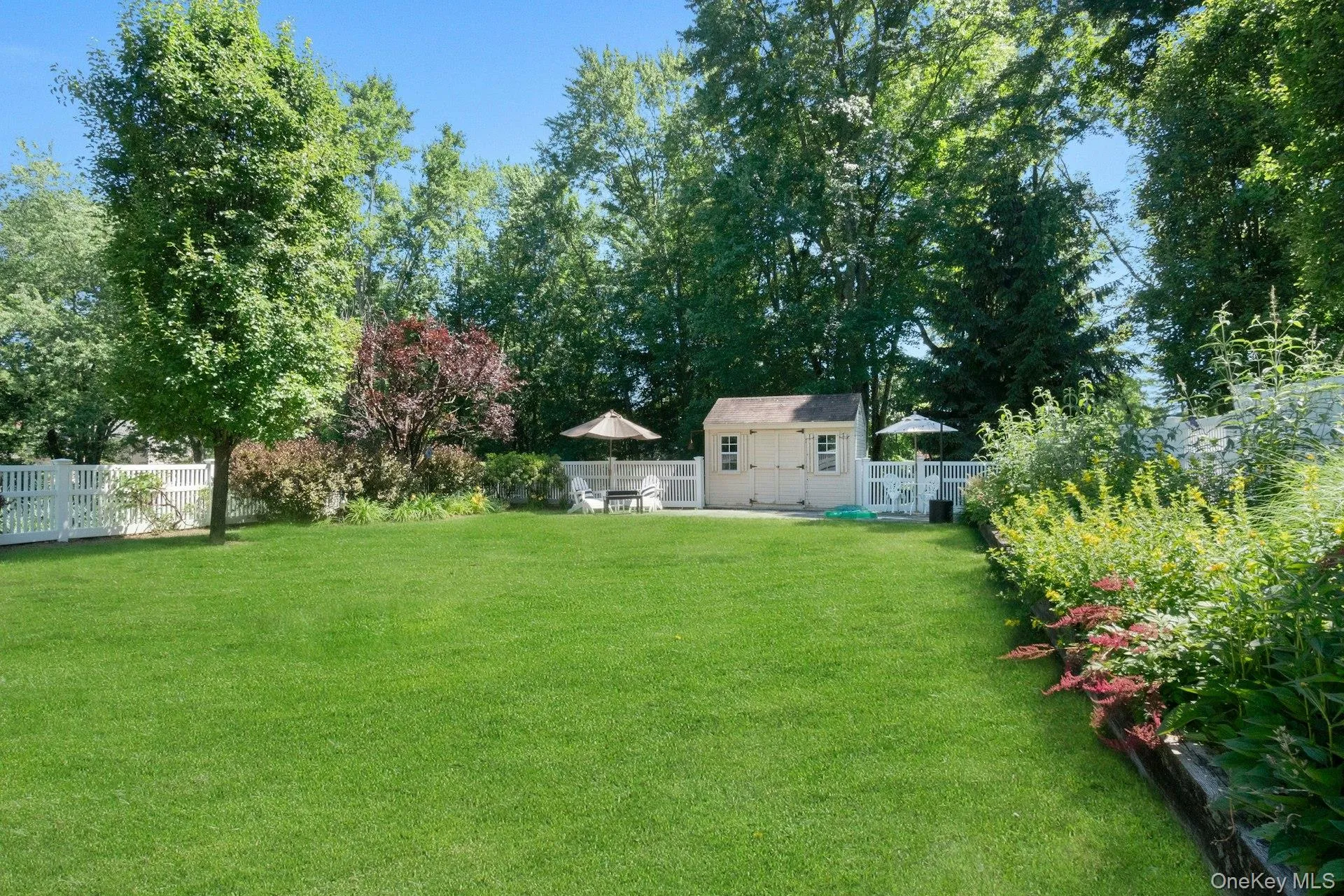 Lovely perennial gardens line the fenced play yard. Lovely perennial gardens line the fenced play yard.