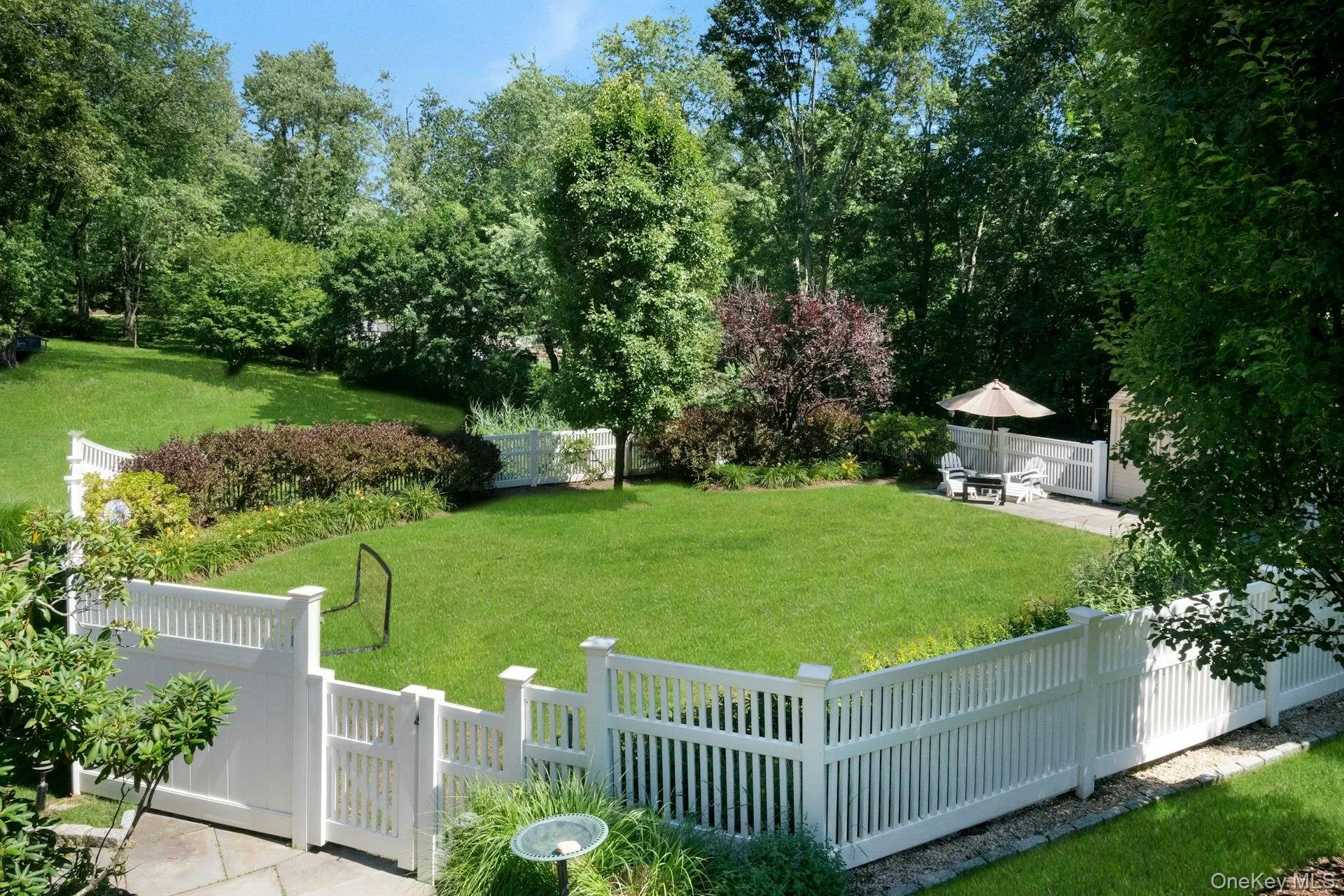 Fenced, level play yard area perfect for relaxing, playing ball. Fenced, level play yard area perfect for relaxing, playing ball.