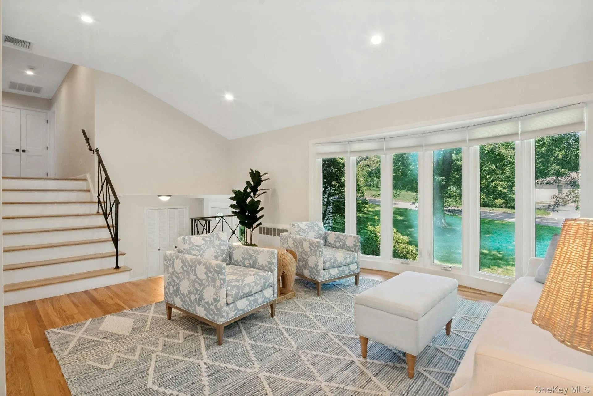 Upstairs to living room with bright bay window and recessed lighting in high ceilings Upstairs to living room with bright bay window and recessed lighting in high ceilings