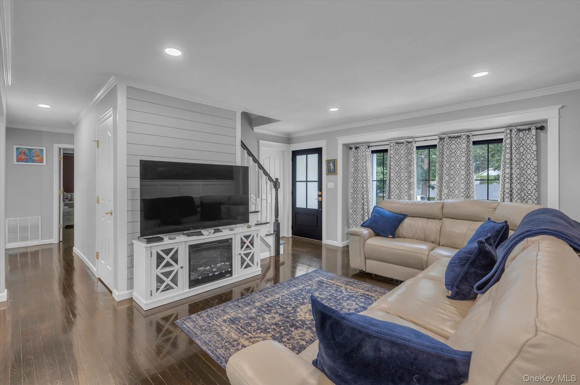 Open concept. Direct access to dining area and kitchen. Feature wall with shiplap detail. Open concept. Direct access to dining area and kitchen. Feature wall with shiplap detail.