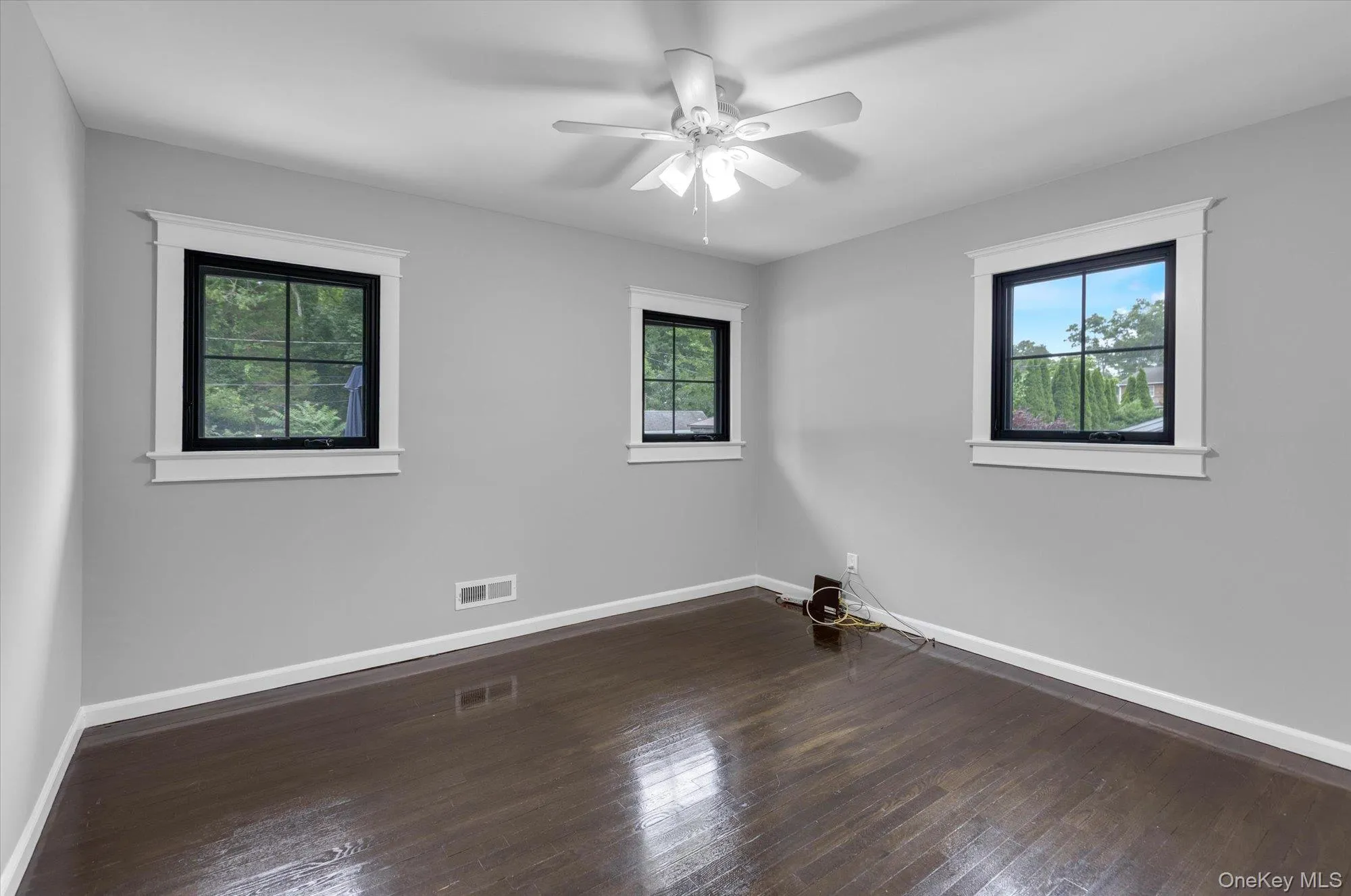 Second bedroom on first level with wood flooring and plenty of windows to let in natural light. Second bedroom on first level with wood flooring and plenty of windows to let in natural light.