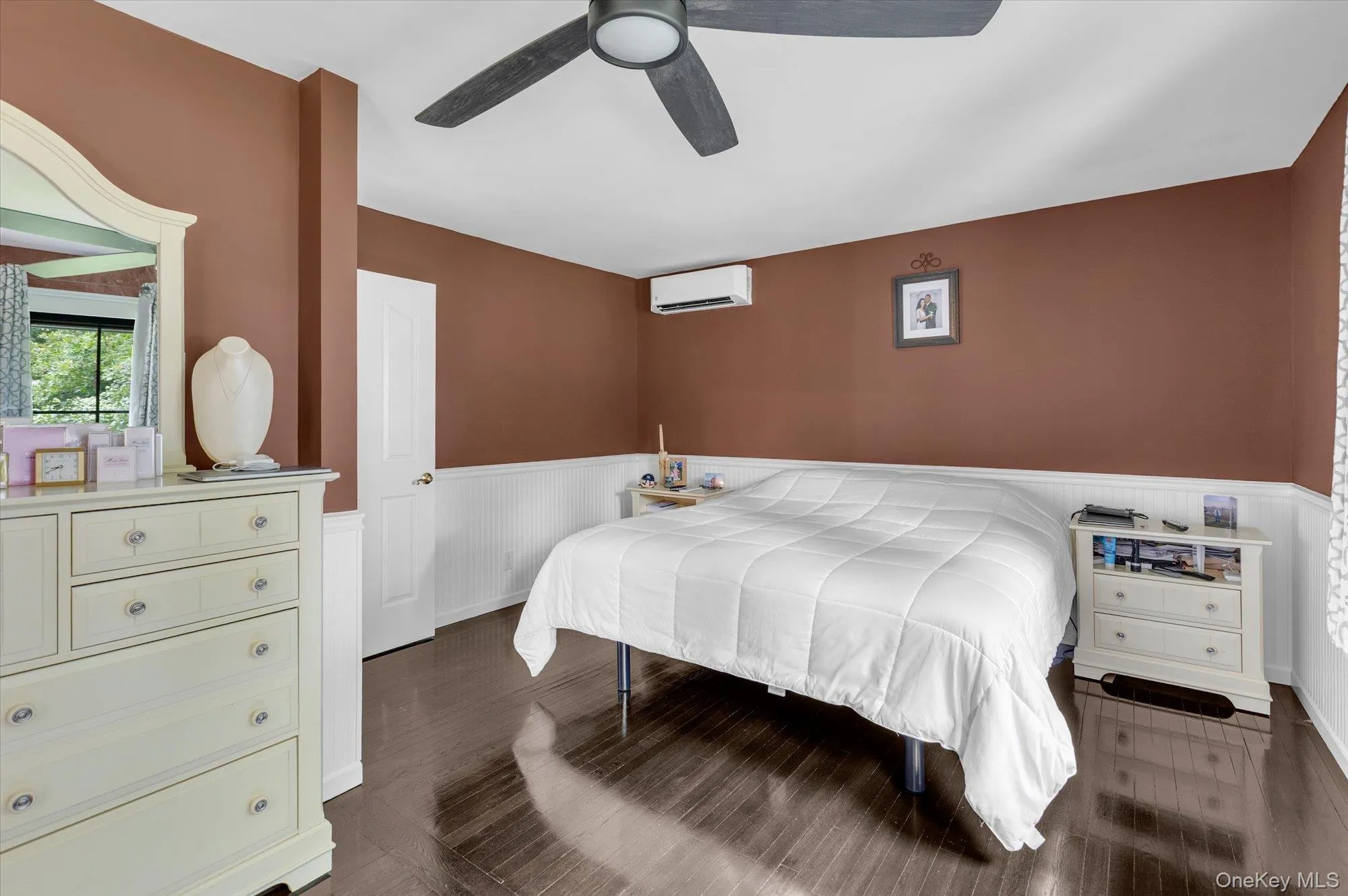 Wood flooring, modern ceiling fan and bead board wainscoting detail. Wood flooring, modern ceiling fan and bead board wainscoting detail.