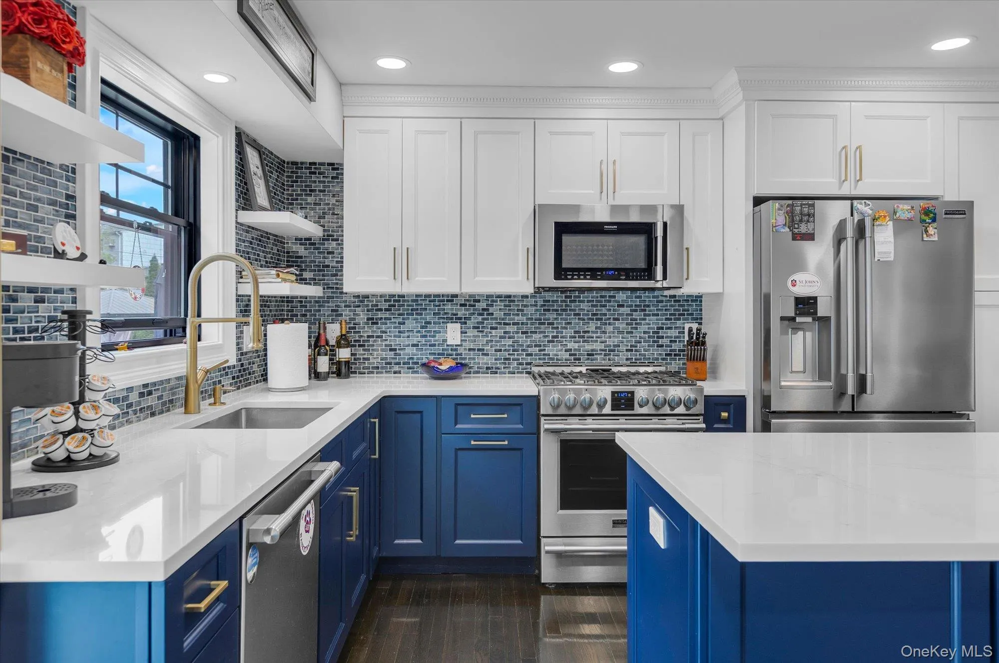 Two tone cabinetry with stainless steel appliances and recessed lighting. Two tone cabinetry with stainless steel appliances and recessed lighting.