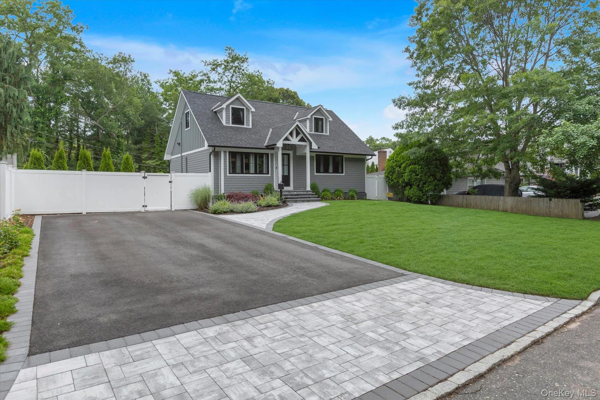 Front lawn with driveway and privacy fence. Front lawn with driveway and privacy fence.
